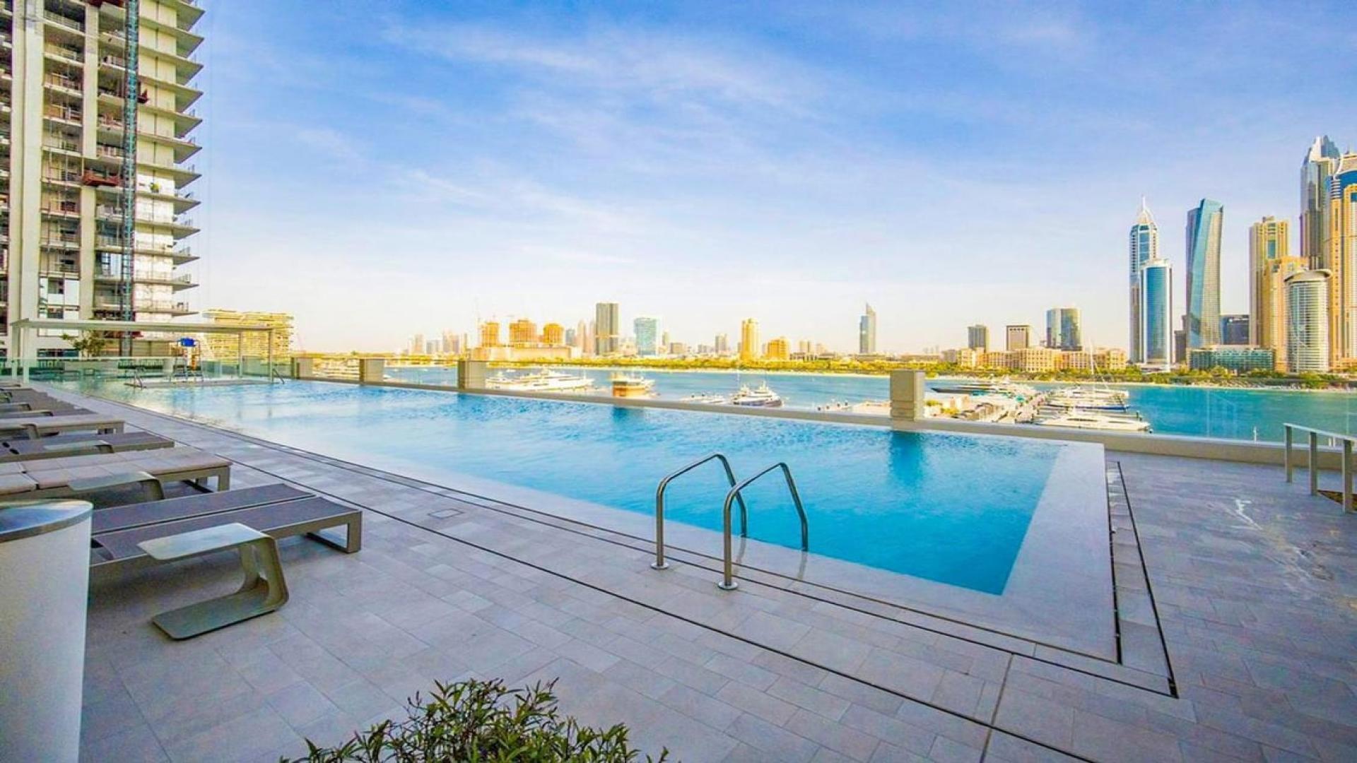 Modern living room in elegant Emaar Beachfront apartment, Dubai Harbour, with stylish furnishings