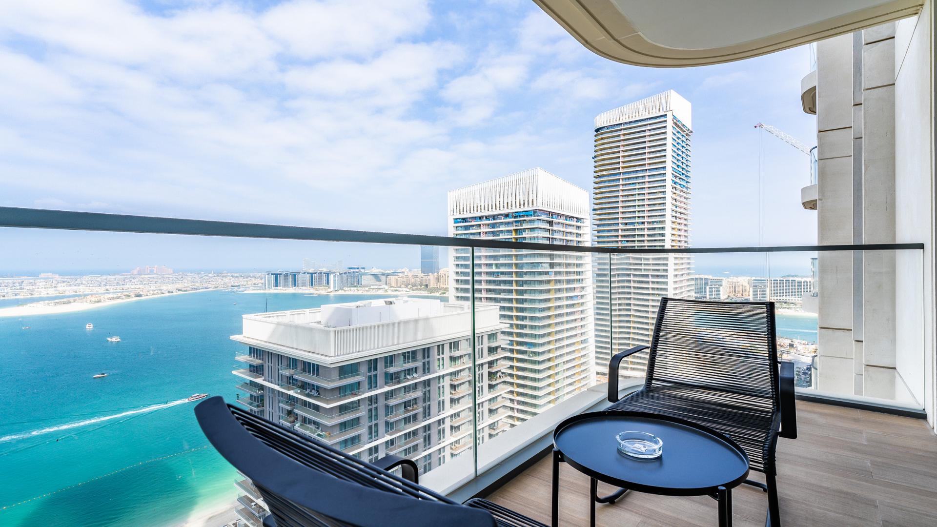 "Modern living room and dining area in Dubai Harbour apartment with marina view balcony.",Stunning marina view from Dubai Harbour apartment balcony at Emaar Beachfront, LP44219