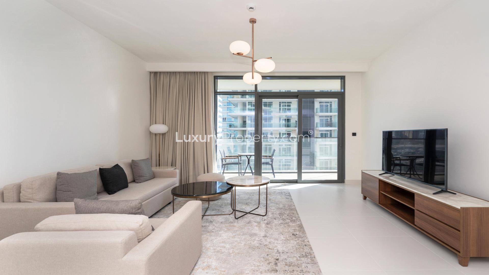 "Spacious balcony view overlooking Dubai Harbour skyline and marina at Emaar Beachfront apartment.",Modern living room in 1-bedroom apartment, Marina Vista, Dubai Harbour, Emaar Beachfront