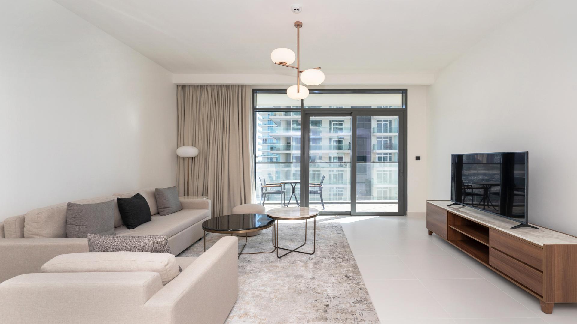 "Spacious balcony view overlooking Dubai Harbour skyline and marina at Emaar Beachfront apartment.",Modern living room in 1-bedroom apartment, Marina Vista, Dubai Harbour, Emaar Beachfront