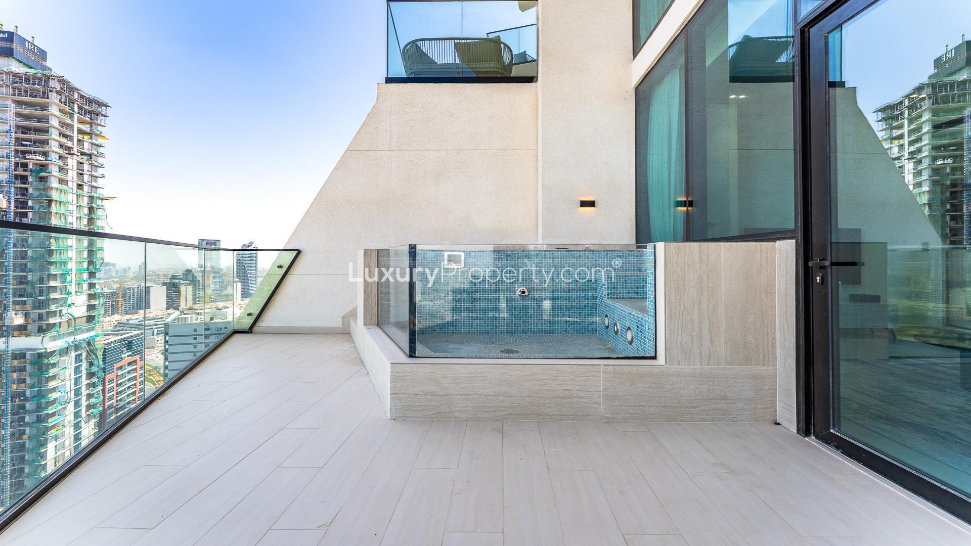 Modern bedroom in Jumeirah Village Circle apartment, featuring stylish decor and cozy ambiance