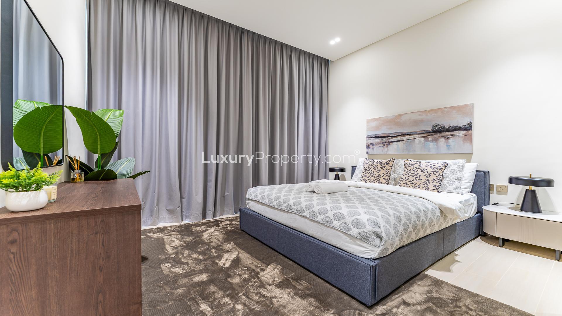 Modern kitchen and dining area in Jumeirah Village Circle apartment, District 18