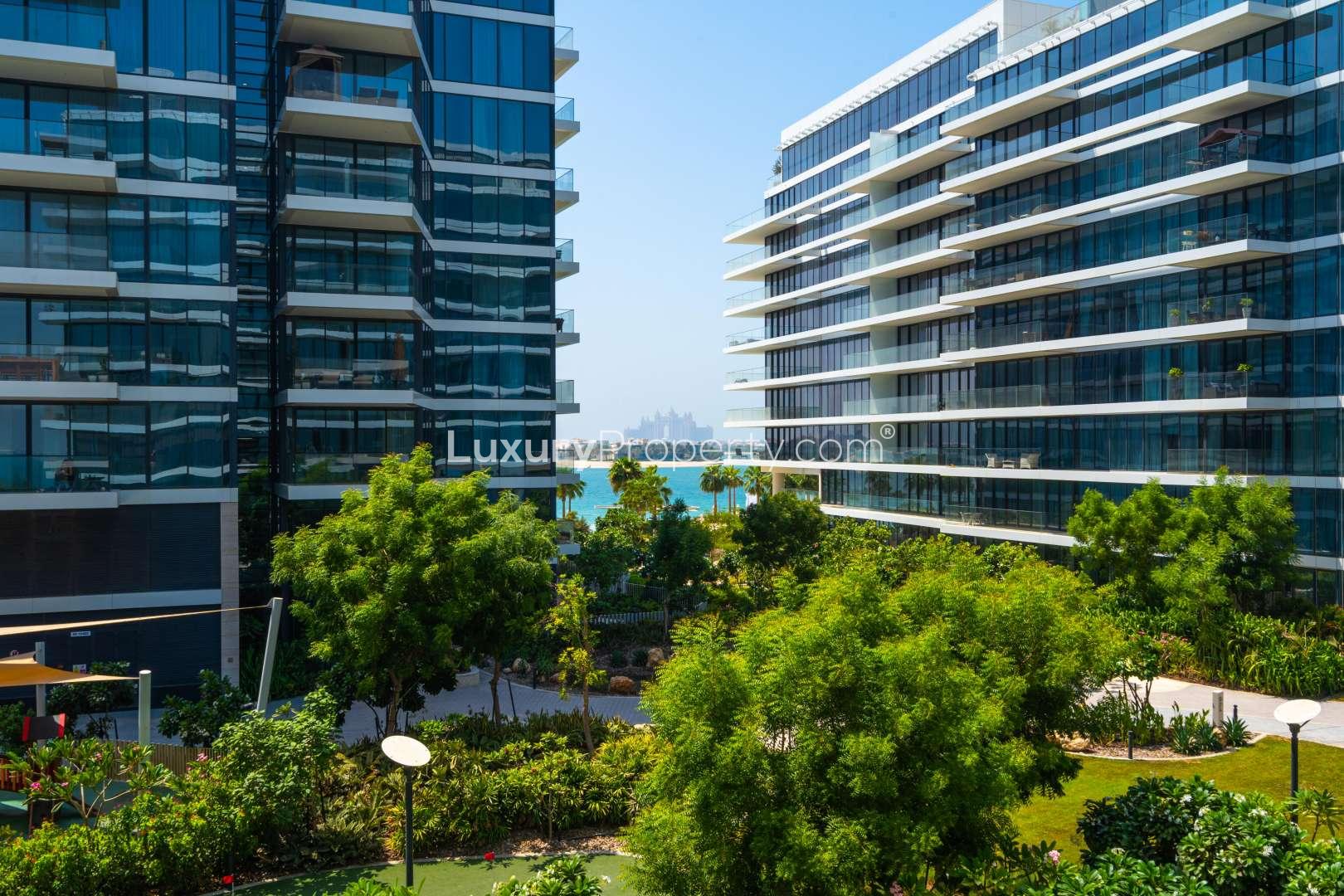 "Modern apartment buildings with lush gardens at Serenia Residences, Palm Jumeirah, Dubai.",Empty bedroom with wooden wardrobe in Serenia Residence, Palm Jumeirah apartment for sale