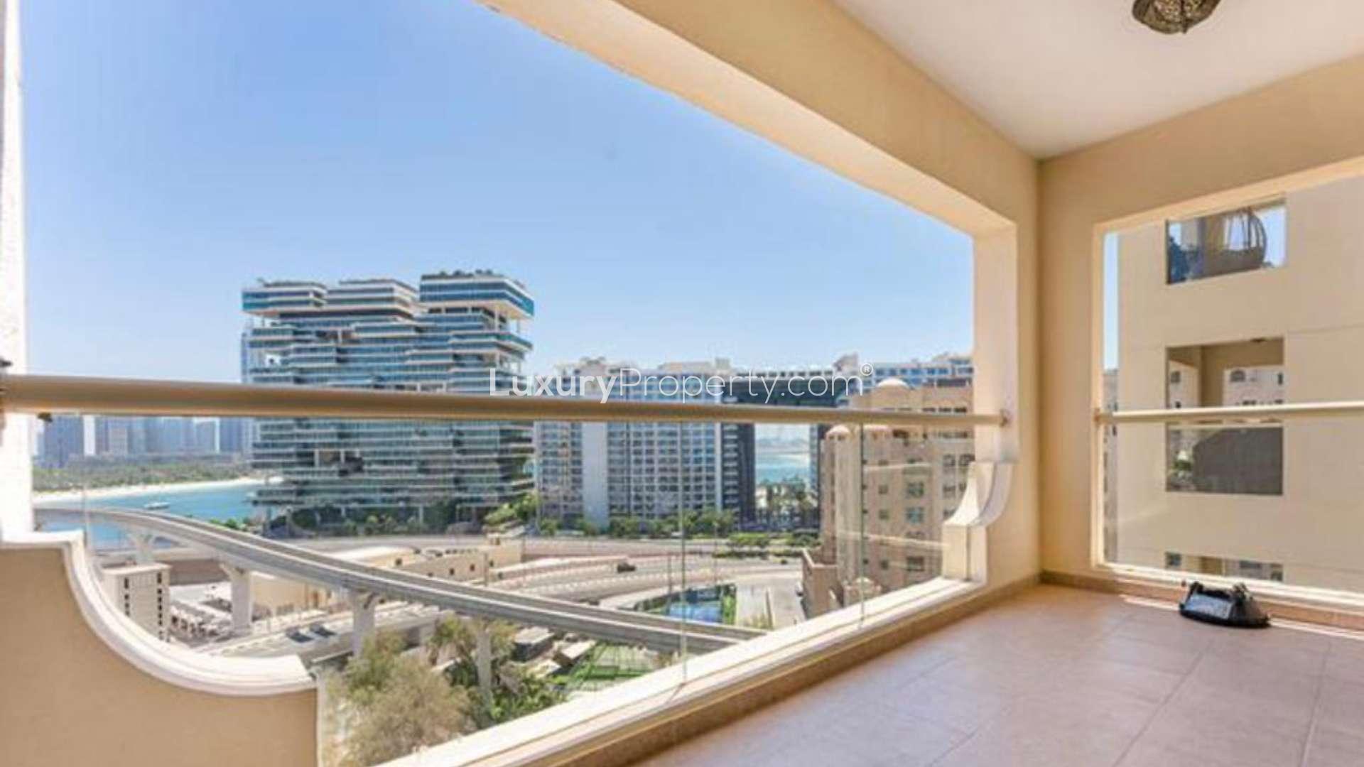 Night view of Shoreline Apartments, Palm Jumeirah with city lights and roads