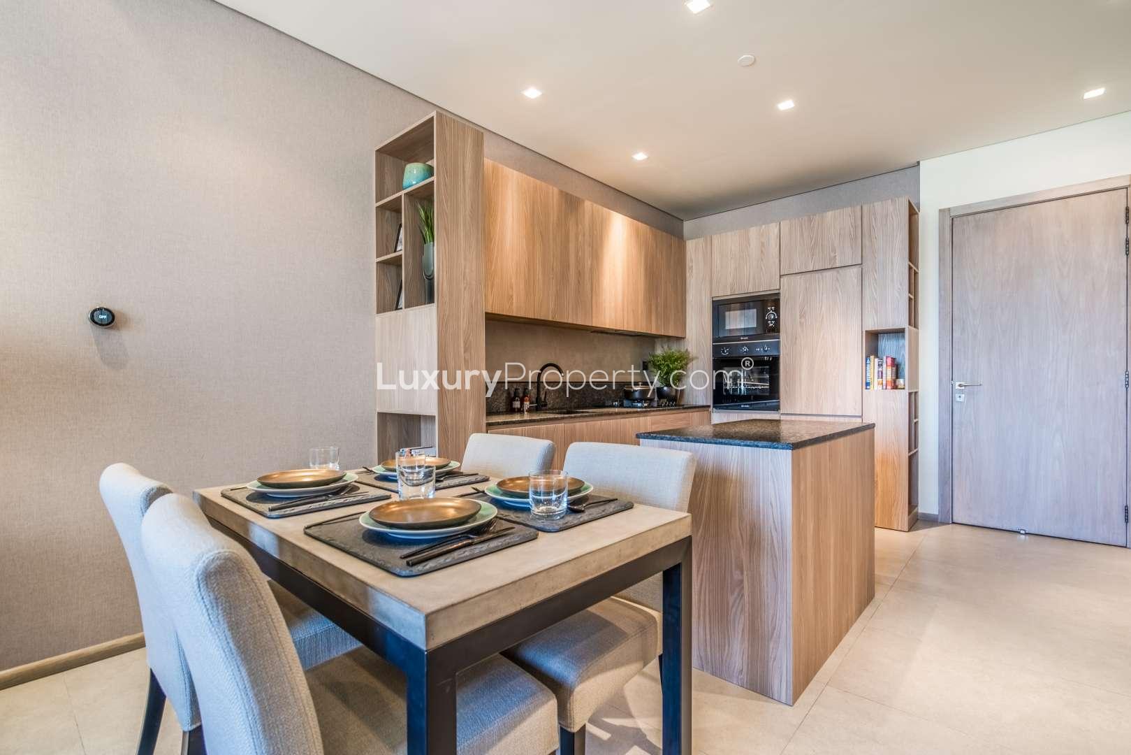 Eco-friendly 1-bedroom apartment interior with modern kitchen and living area in JVC, Dubai