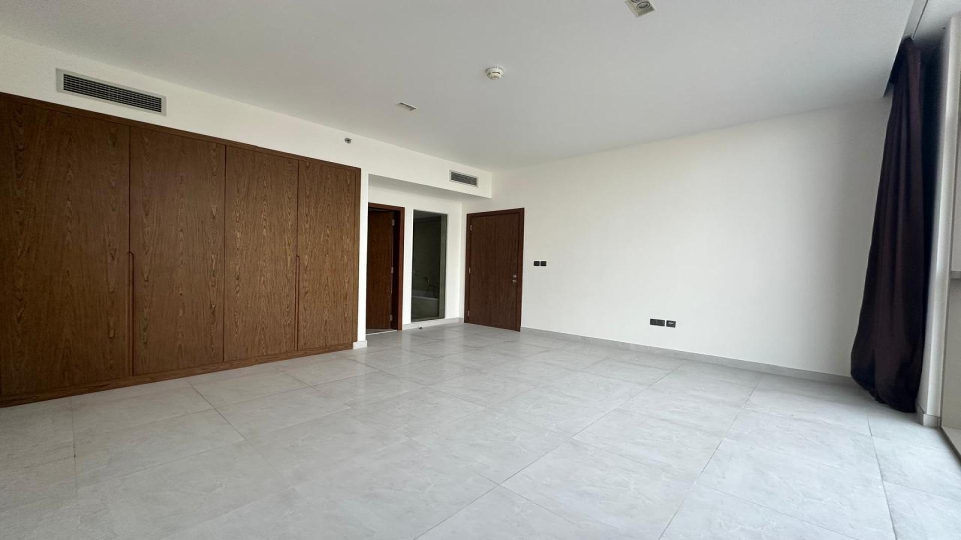 Bright bedroom with large window and built-in closet in Dubai Marina apartment for sale