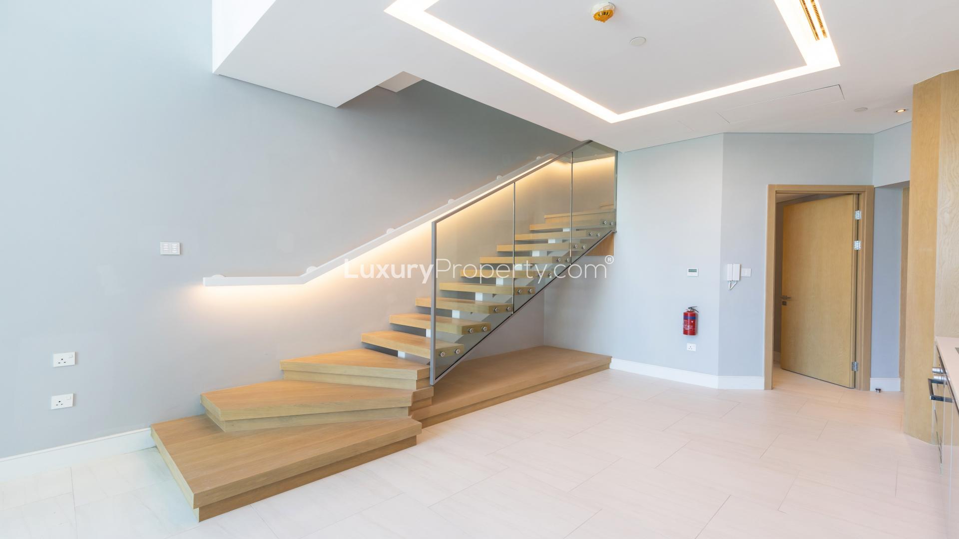 Modern apartment interior with high ceilings and glass staircase, Business Bay, Dubai
