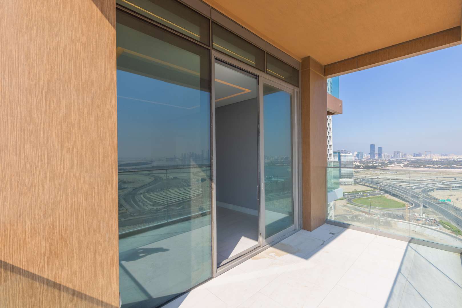 Apartment interior with wooden cabinets and large windows overlooking Downtown Dubai in Business Bay