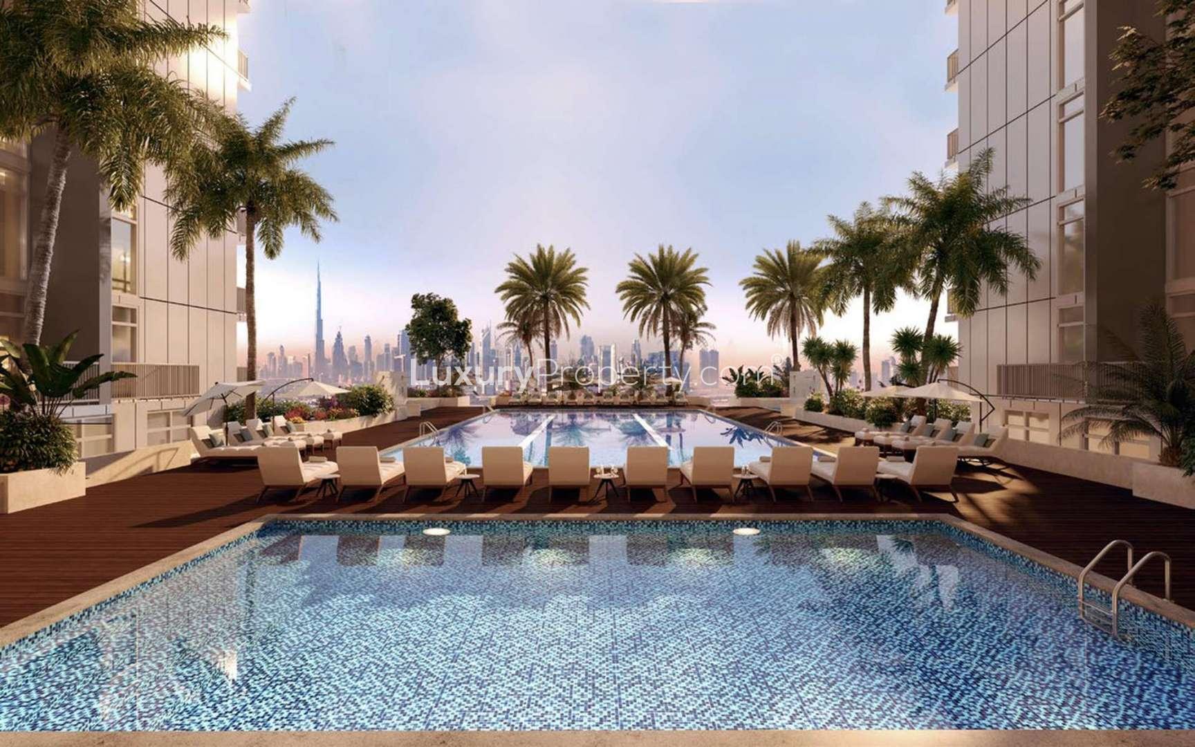 "Modern glass apartment in Sobha Creek Reserve, Dubai with scenic sunset view over cityscape.",Outdoor pool area at Sobha Creek Reserve apartment, Dubai, with city skyline view