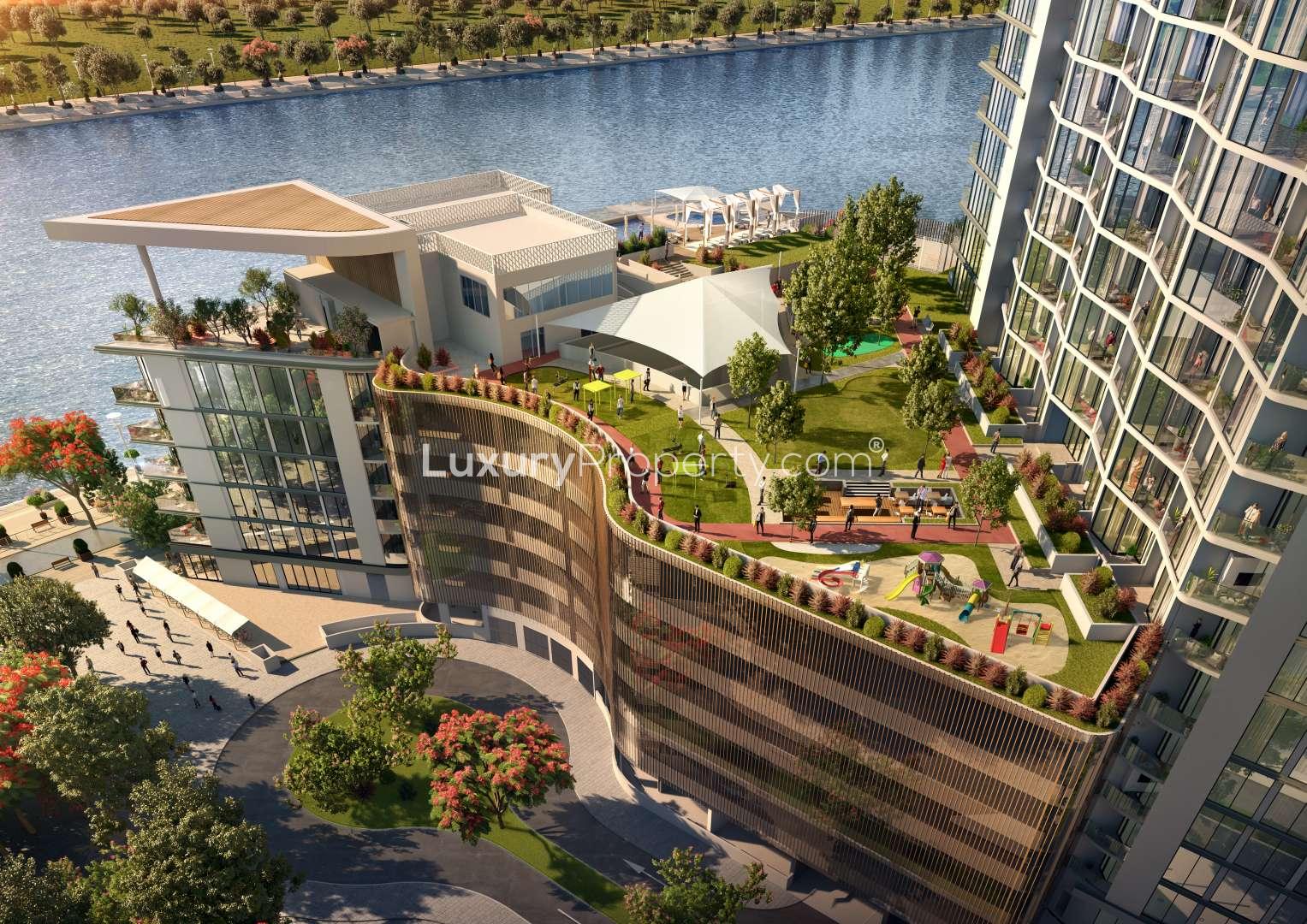 Stunning Sobha Hartland one-bedroom apartment living room with lake view, modern decor, and natural light