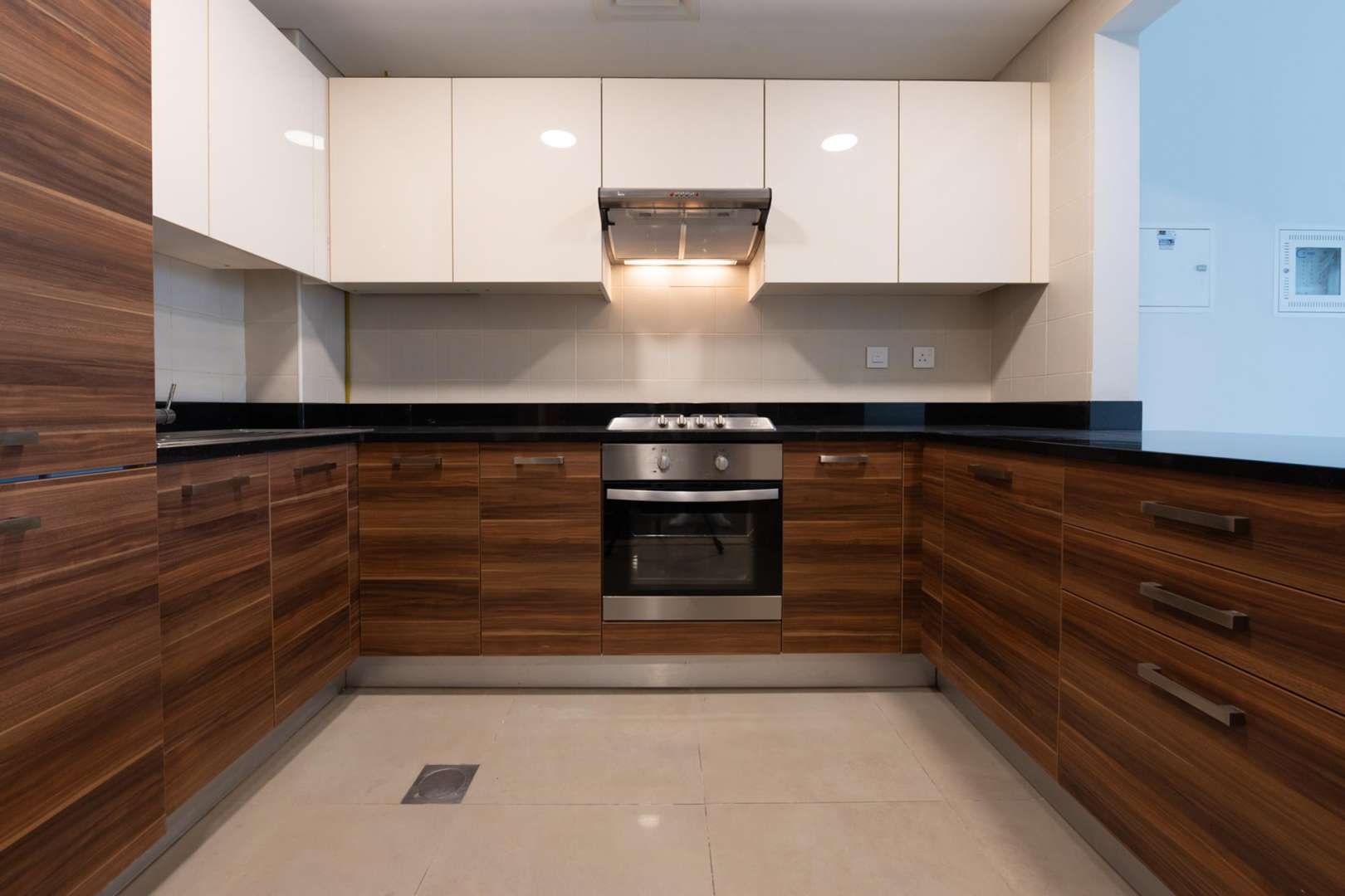 Empty living room in Sparkle Towers apartment, Dubai Marina, with large window view