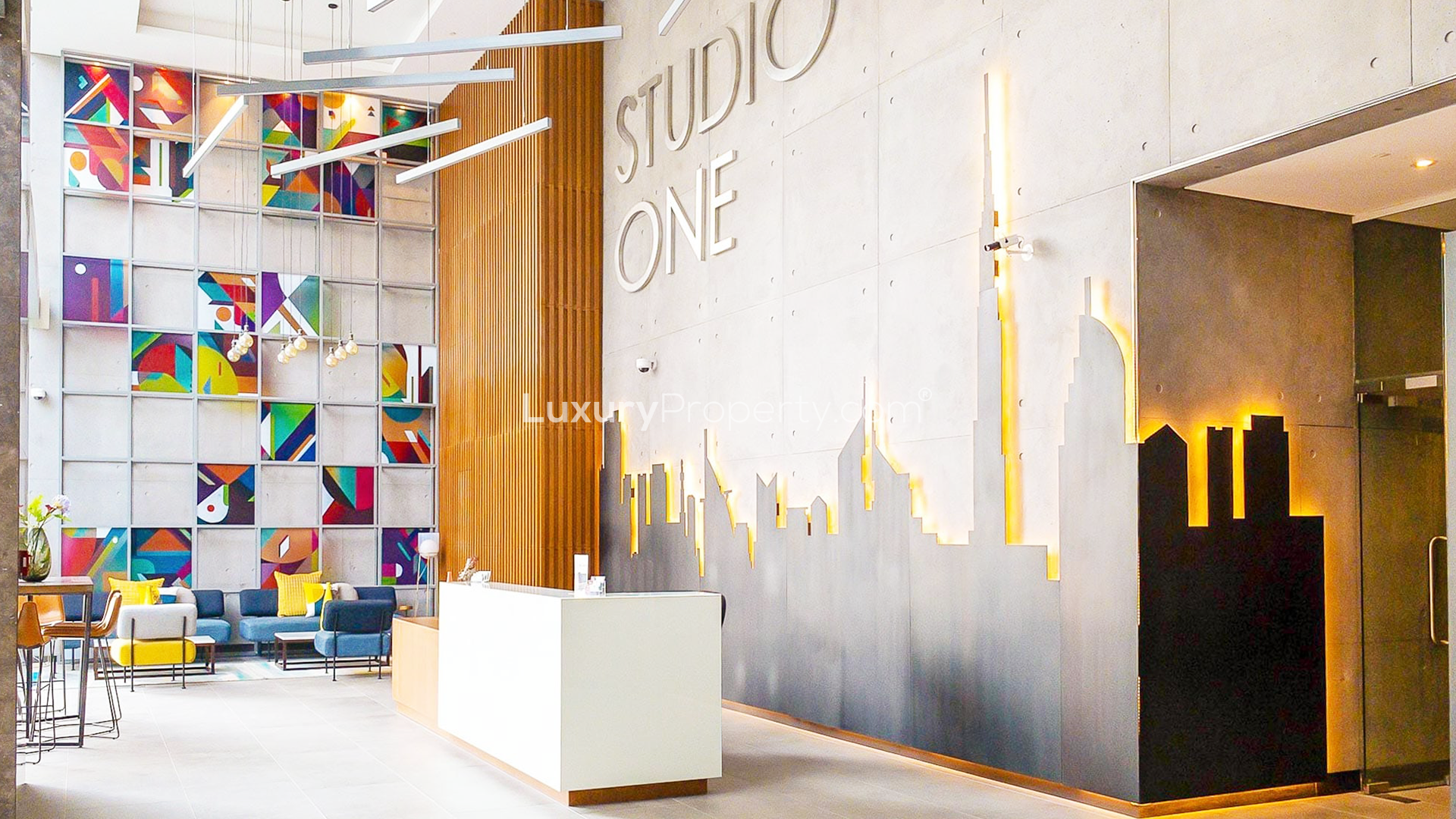 Aerial view of Studio One apartment complex with pool in Dubai Marina at night