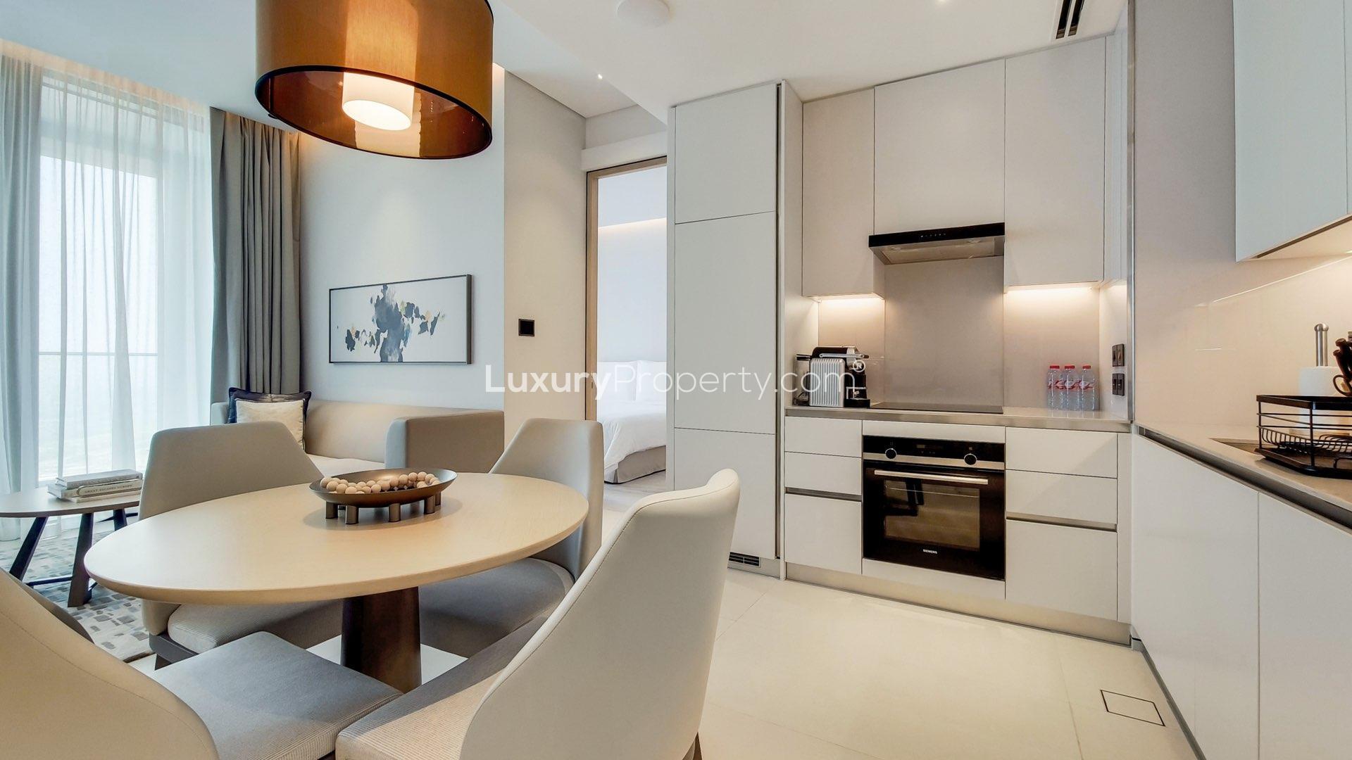 Modern living area in Jumeirah Beach Residence apartment with sleek kitchen and dining space