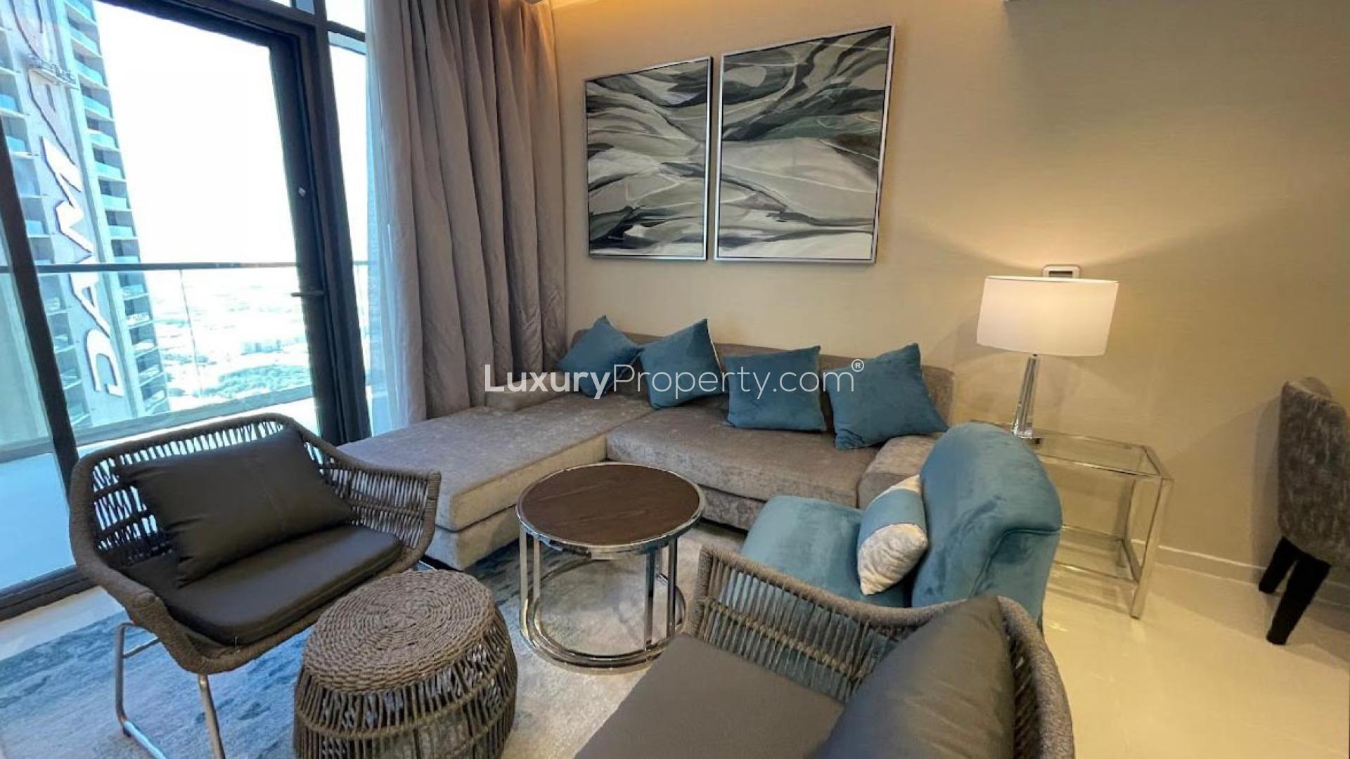 Outdoor pool area at Aykon City B apartment, Business Bay, with lounge chairs and palm trees