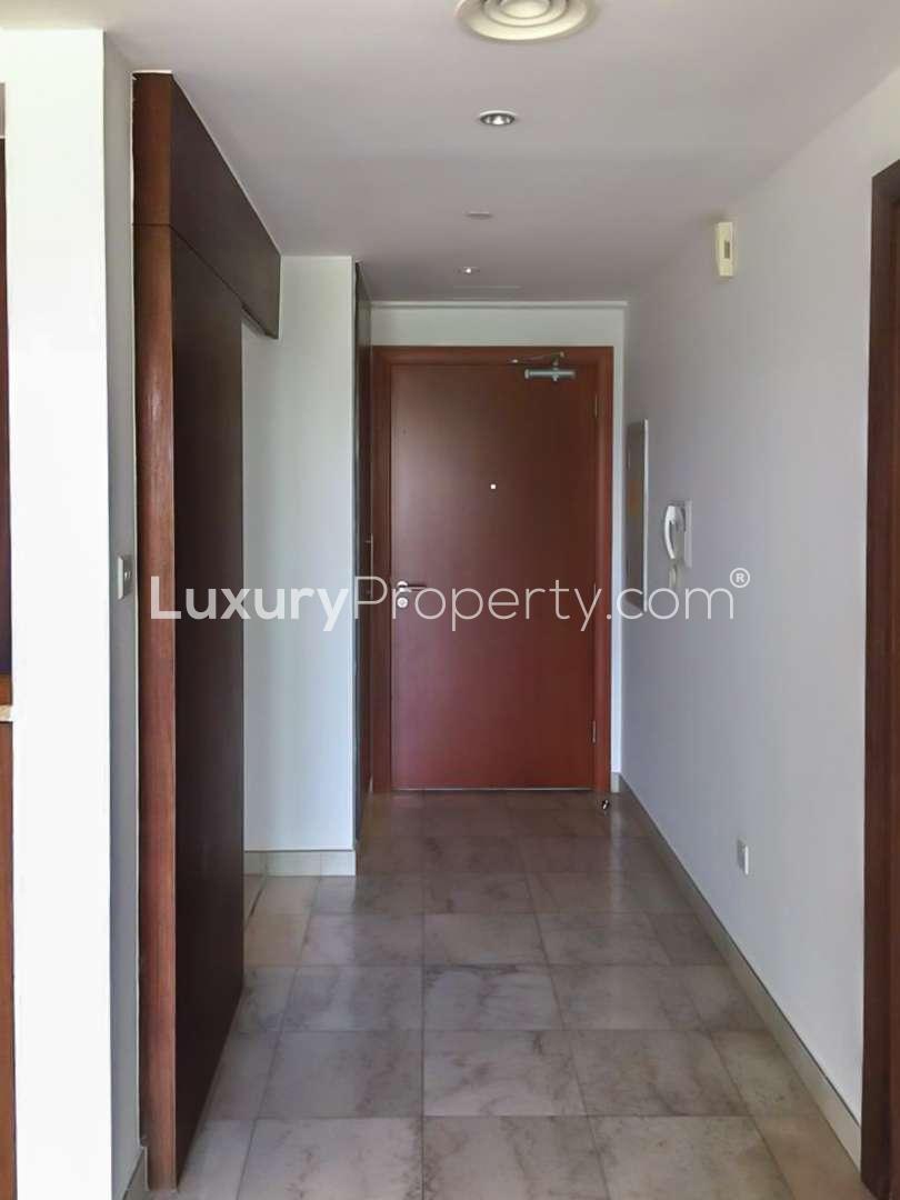 "Bright apartment interior with large window showcasing golf views in The Fairways, The Views.","Spacious hallway in The Fairways apartment, The Views, with elegant wooden door and tiles.","Bright apartment interior with large windows offering scenic golf course views in The Fairways.",Modern bathroom in The Fairways apartment, featuring bathtub, shower, and tiled walls