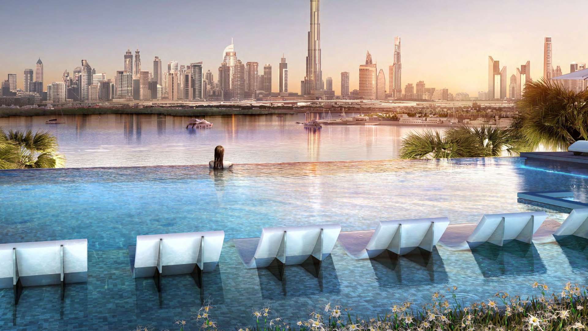Infinity pool view at The Grand, Dubai Creek Harbour, overlooking city skyline at sunset