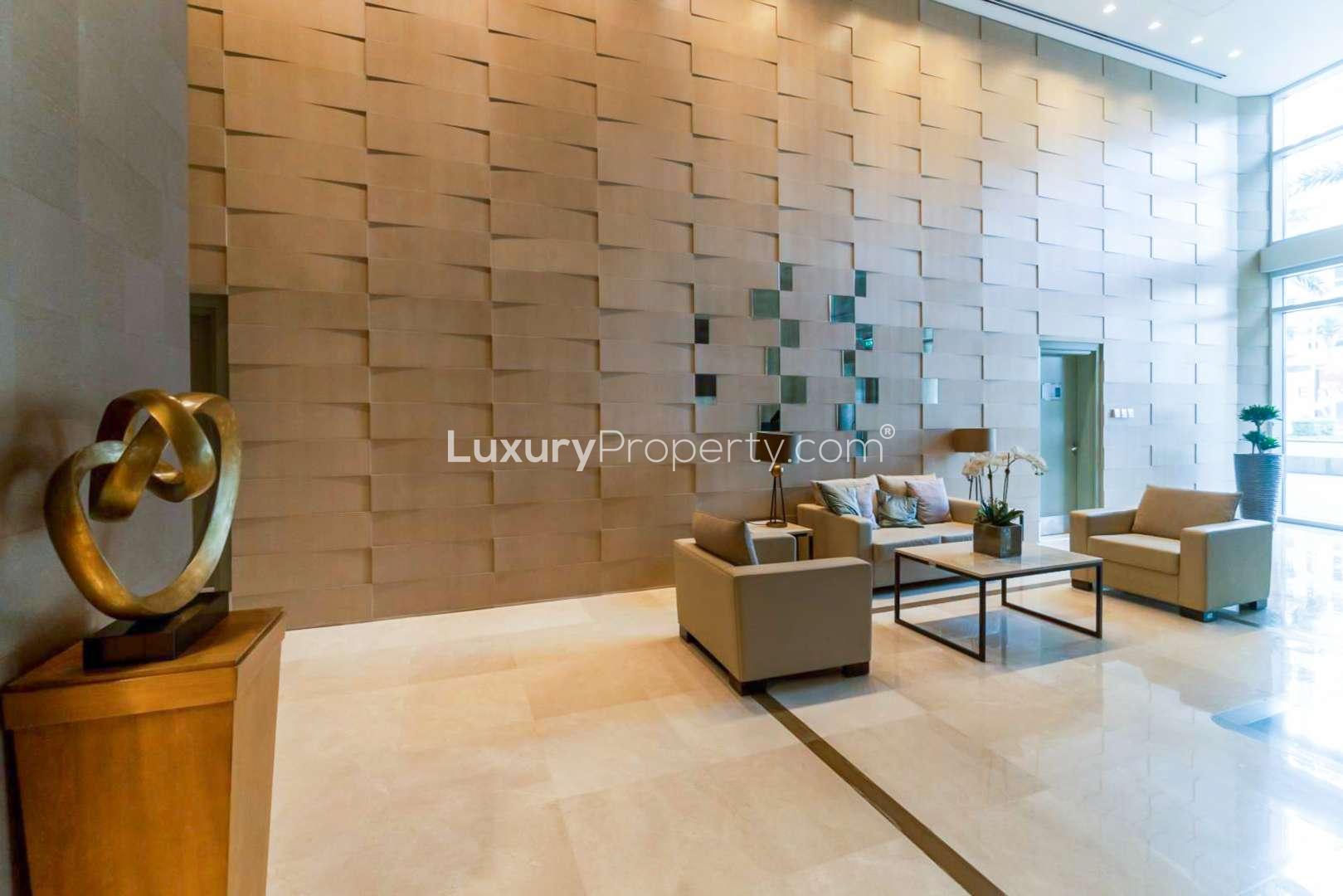 Elegant lobby of The Lofts apartment in Downtown Dubai, featuring modern decor and seating