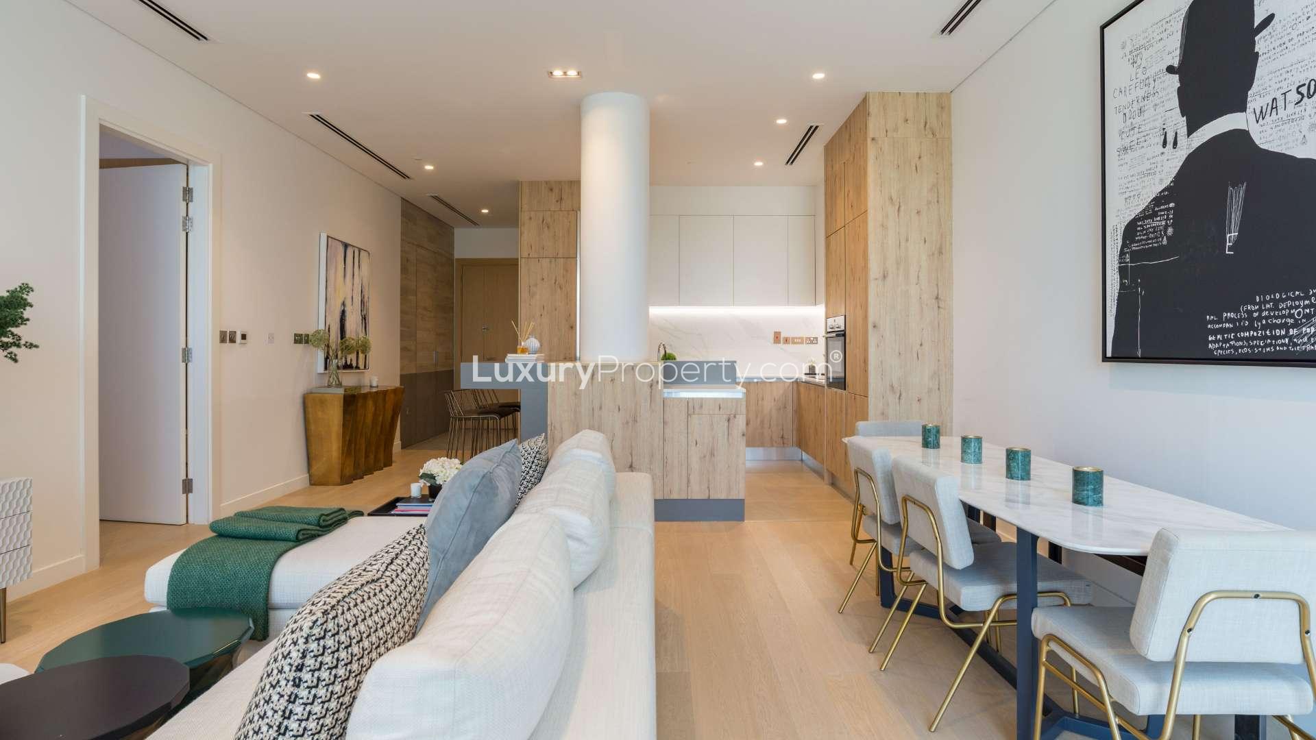 Modern kitchen in Al Barari duplex apartment with wood cabinets and marble countertops