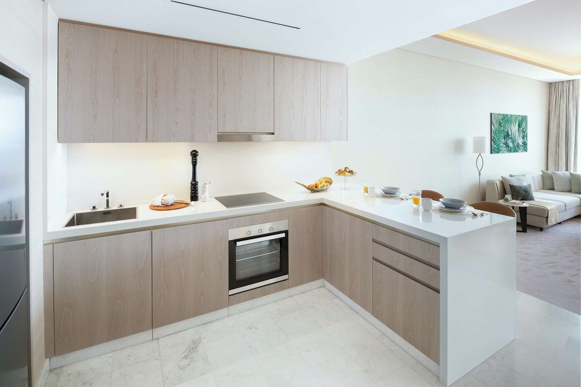 Modern kitchen and living area in one-bedroom Palm Jumeirah apartment for sale