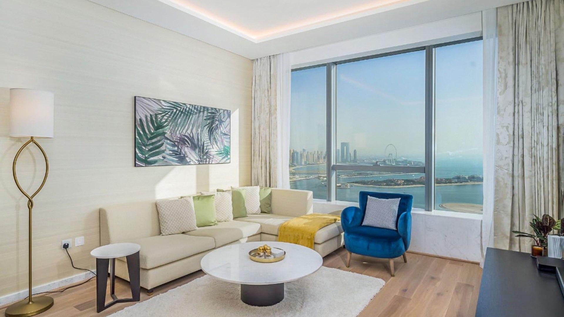 High-floor Palm Jumeirah apartment interior with marina views, modern decor, and dining area