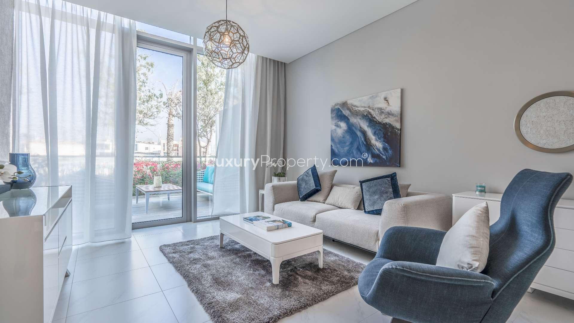 Modern kitchen and living area in District One apartment with Crystal Lagoon views