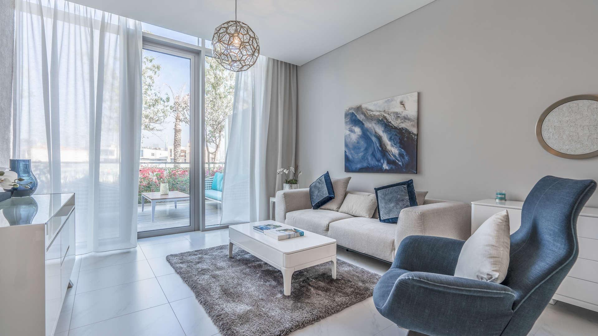 Dining area with yellow chairs in one-bedroom apartment, District One, MBR City for sale