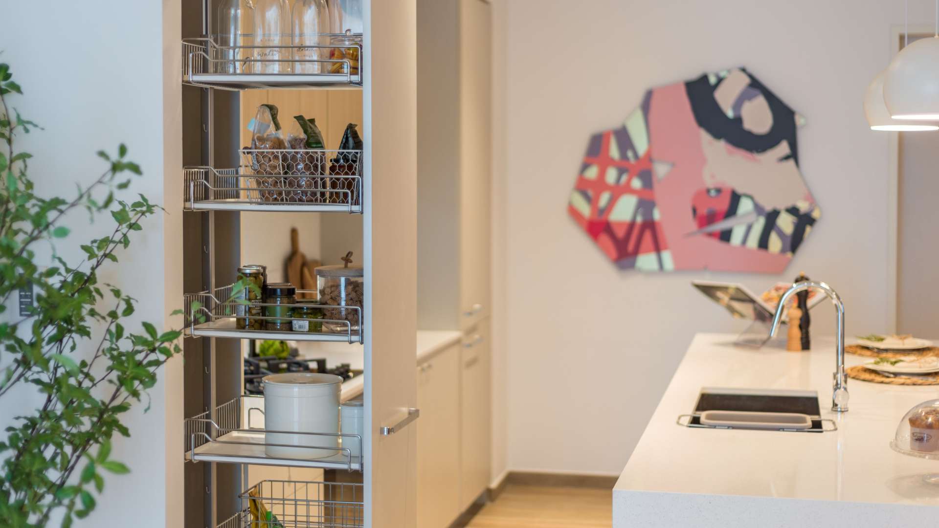 Modern kitchen in Jumeirah Village Circle apartment, featuring sleek countertops and stylish decor