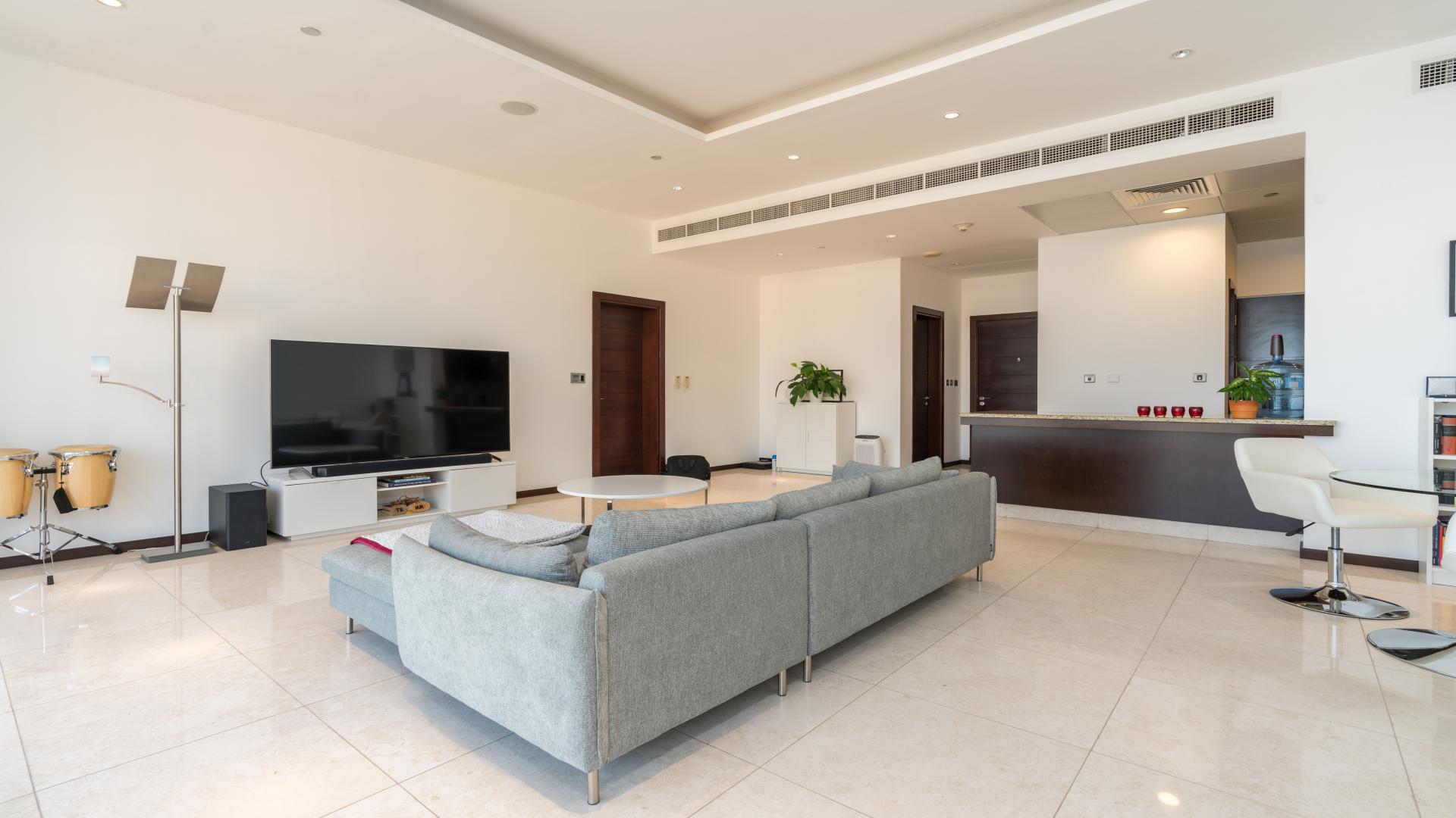 Modern living room in Tiara Residences apartment, Palm Jumeirah, with sleek decor and spacious layout