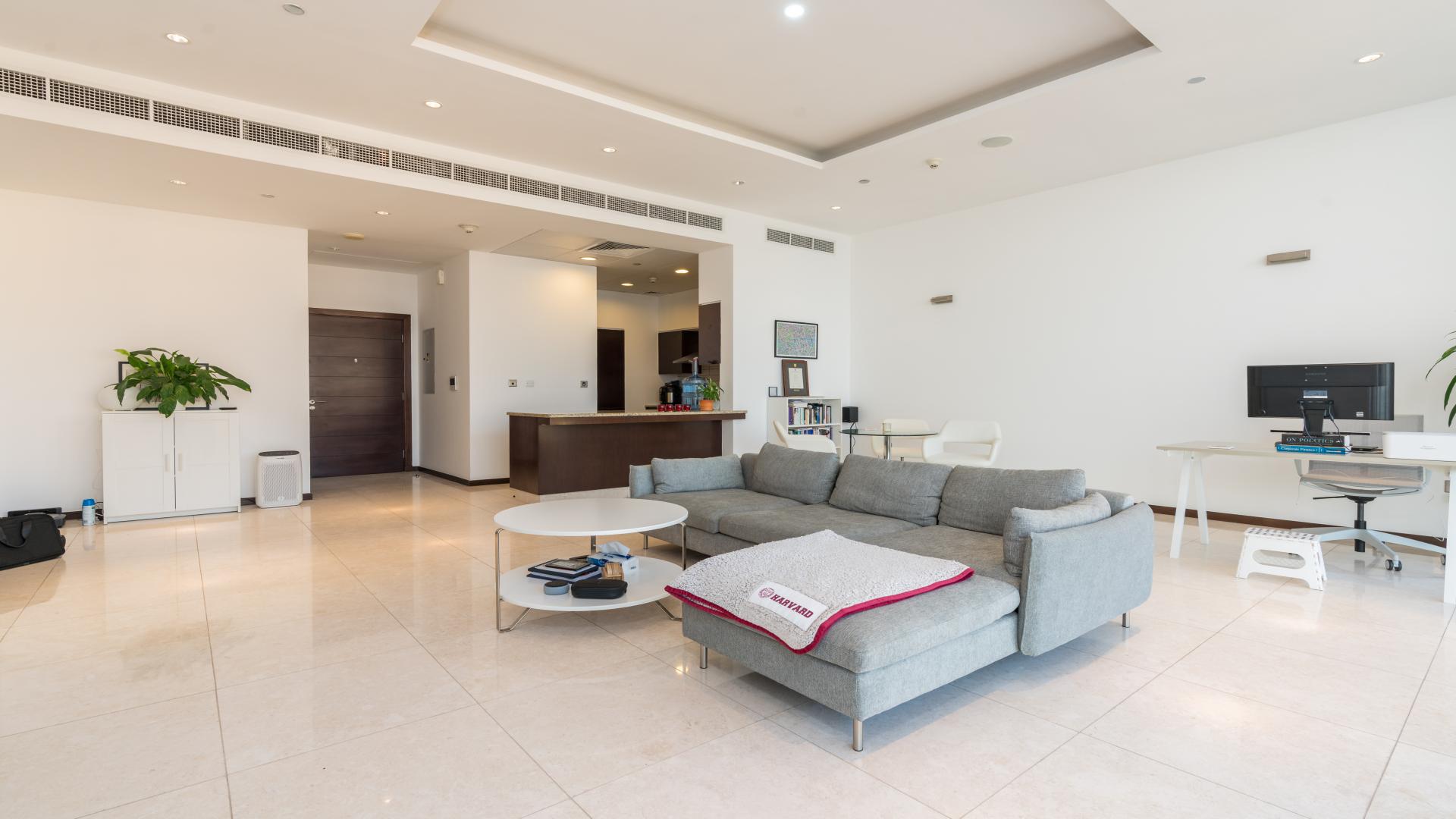 "High-floor apartment balcony view of Tiara Residences, Palm Jumeirah with sea and pool.",Modern living room in Tiara Residences apartment, Palm Jumeirah. Spacious layout and stylish decor