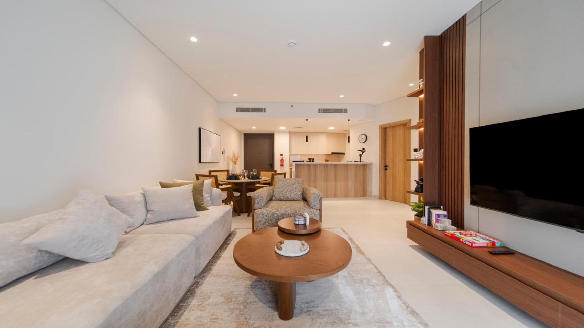 Modern open-plan kitchen and dining area in JVT Milestone Residences apartment for sale