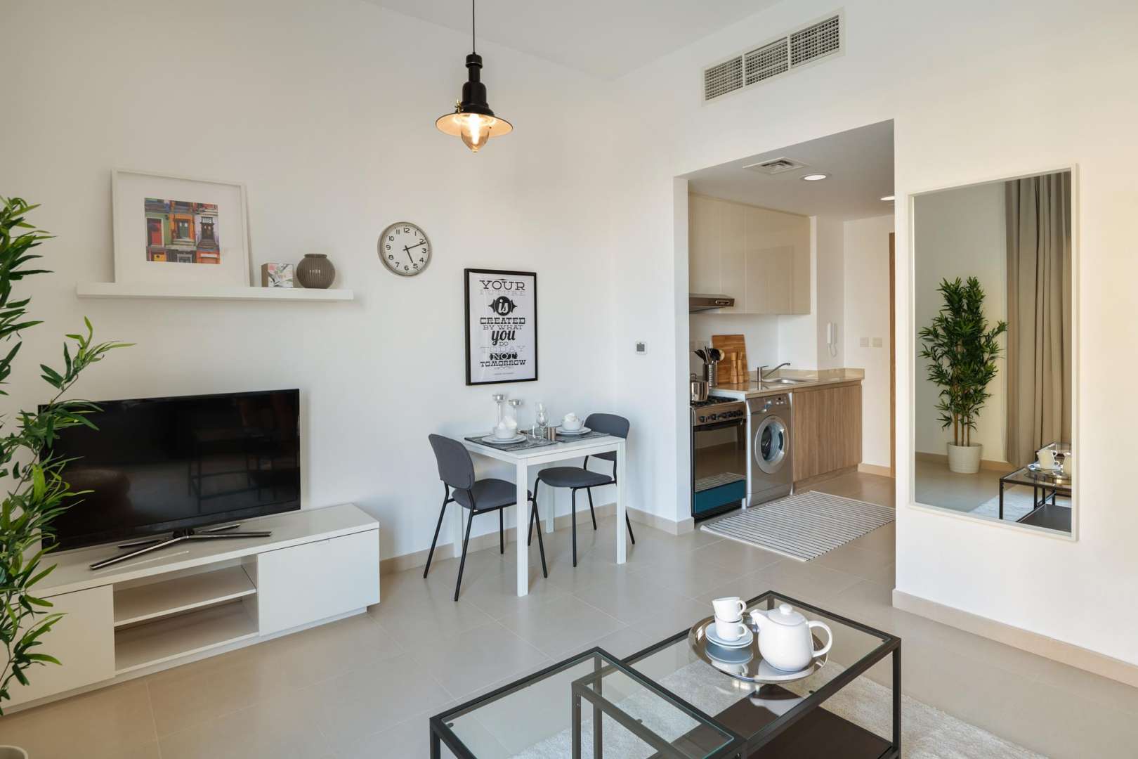 Modern studio apartment living room in UNA, Town Square, Dubai with large window view