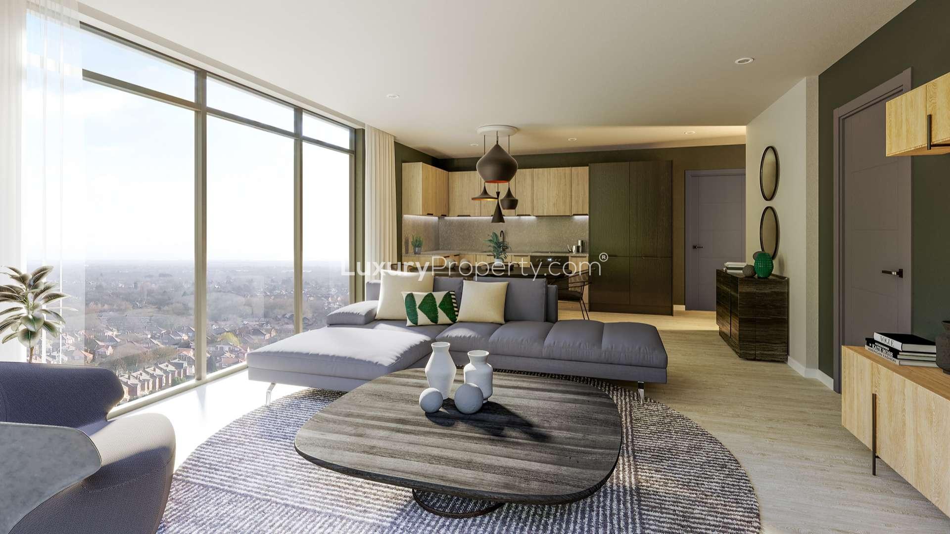 Modern high-rise apartment building in Urban Green, Manchester, surrounded by trees and parked cars