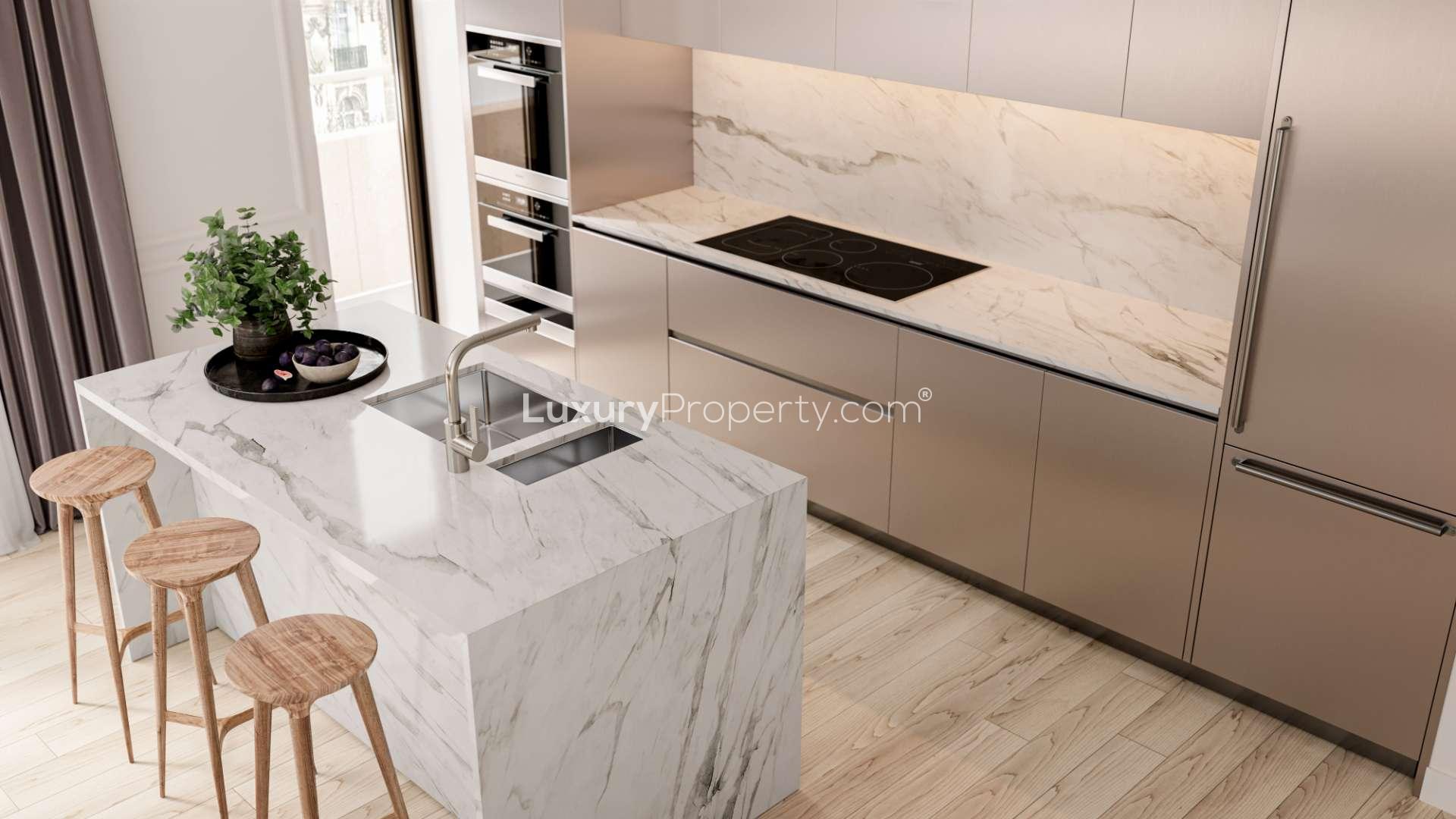 Modern kitchen in stylish W1 Place apartment, featuring sleek design and marble countertops