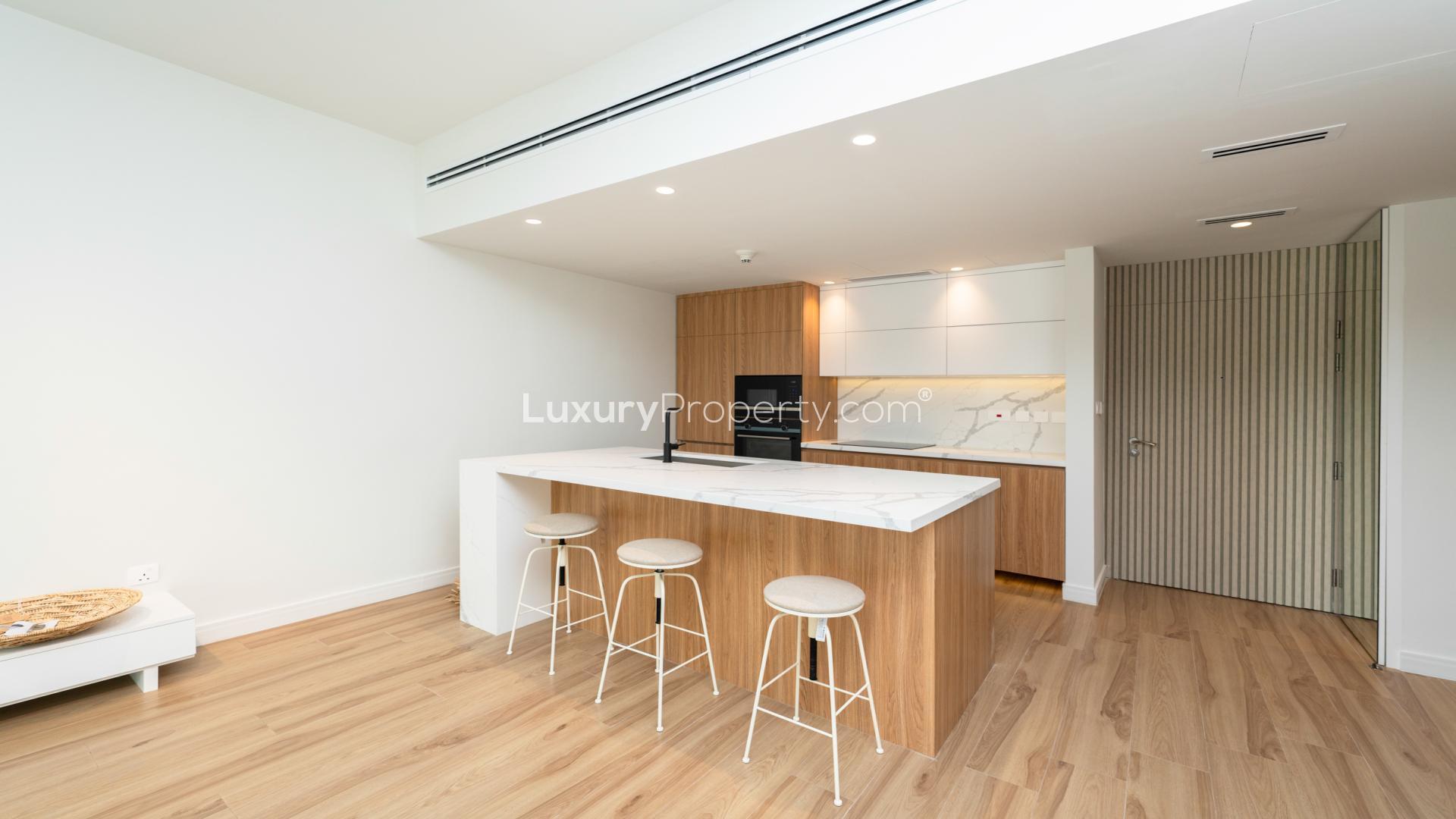 Stylish open-plan kitchen and living area in 1-bedroom apartment, The Greens, Al Dhafra