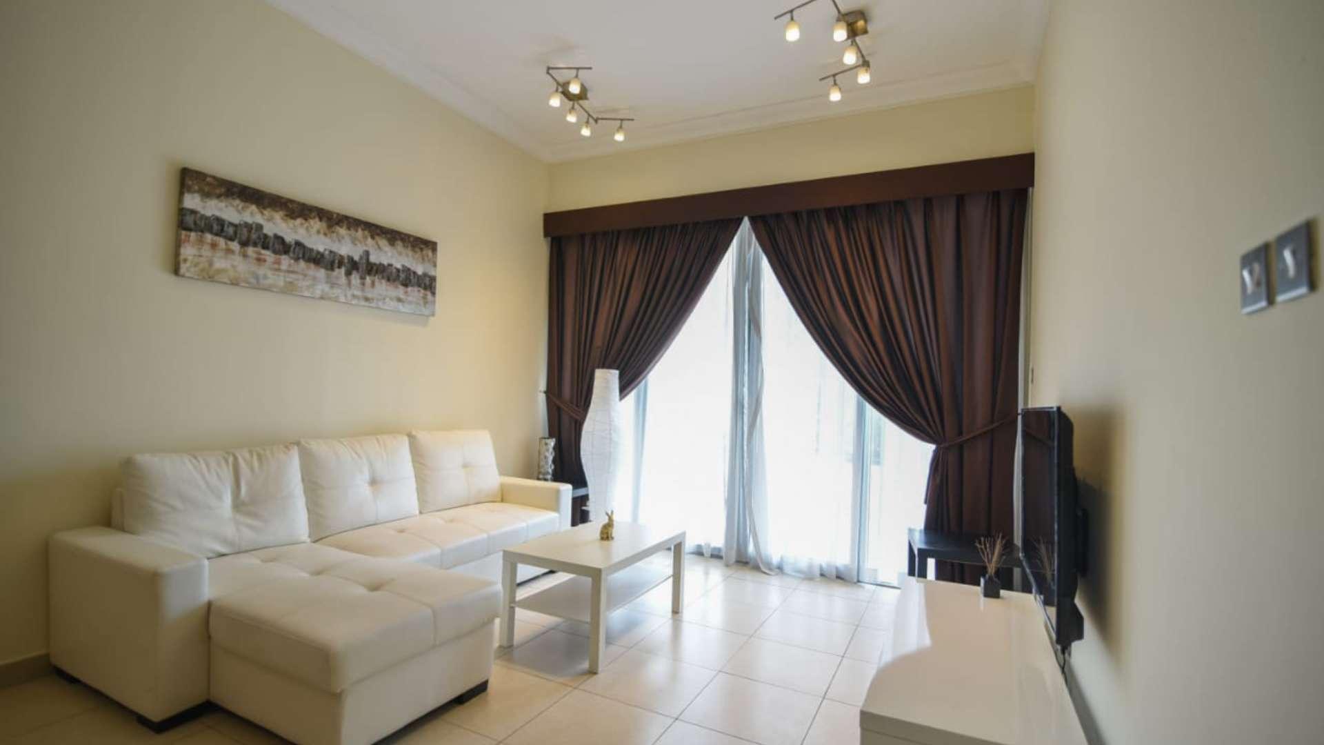 Vacant furnished apartment living room with white sofa, Downtown Dubai, large window curtains