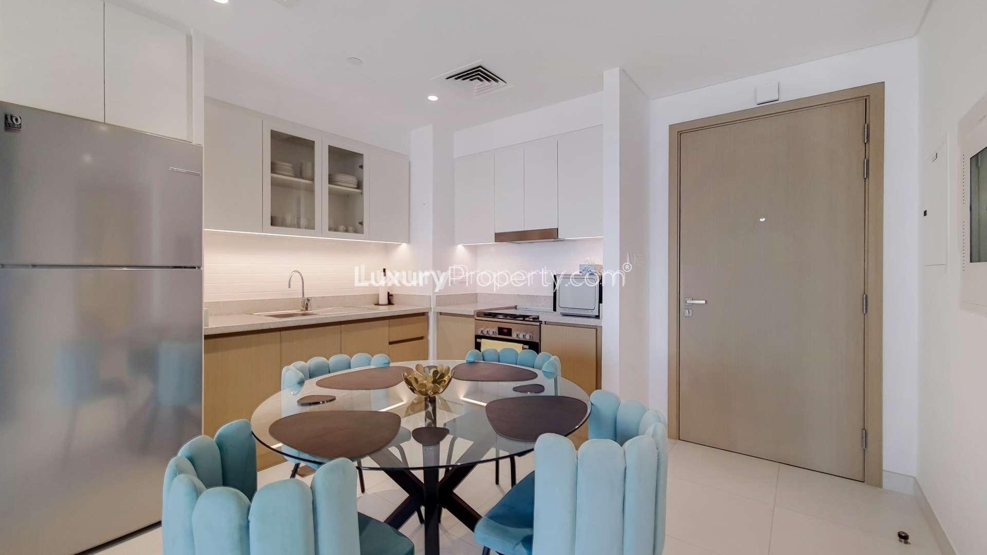 Modern living room in Creek Harbour apartment with balcony, cozy sofa, and stylish decor