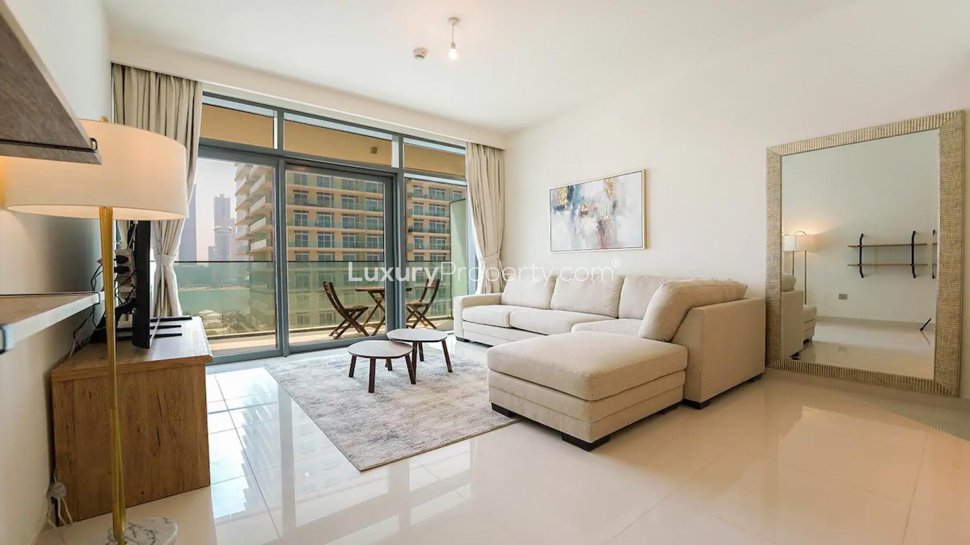 "Modern apartment building in Emaar Beachfront, Dubai Harbour, available for rent.",Brand new furnished living room in Emaar Beachfront apartment, Dubai Harbour, with balcony view