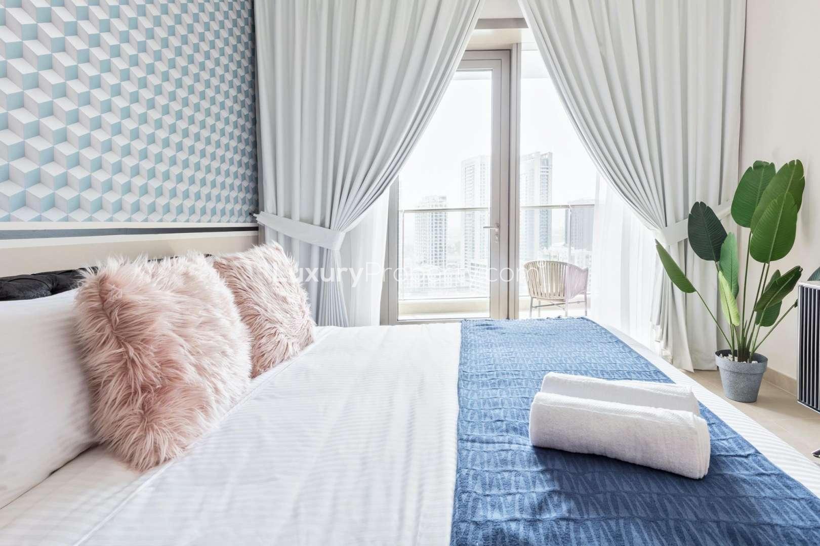 Luxurious bedroom in Sparkle Towers apartment, Dubai Marina with modern decor and balcony view