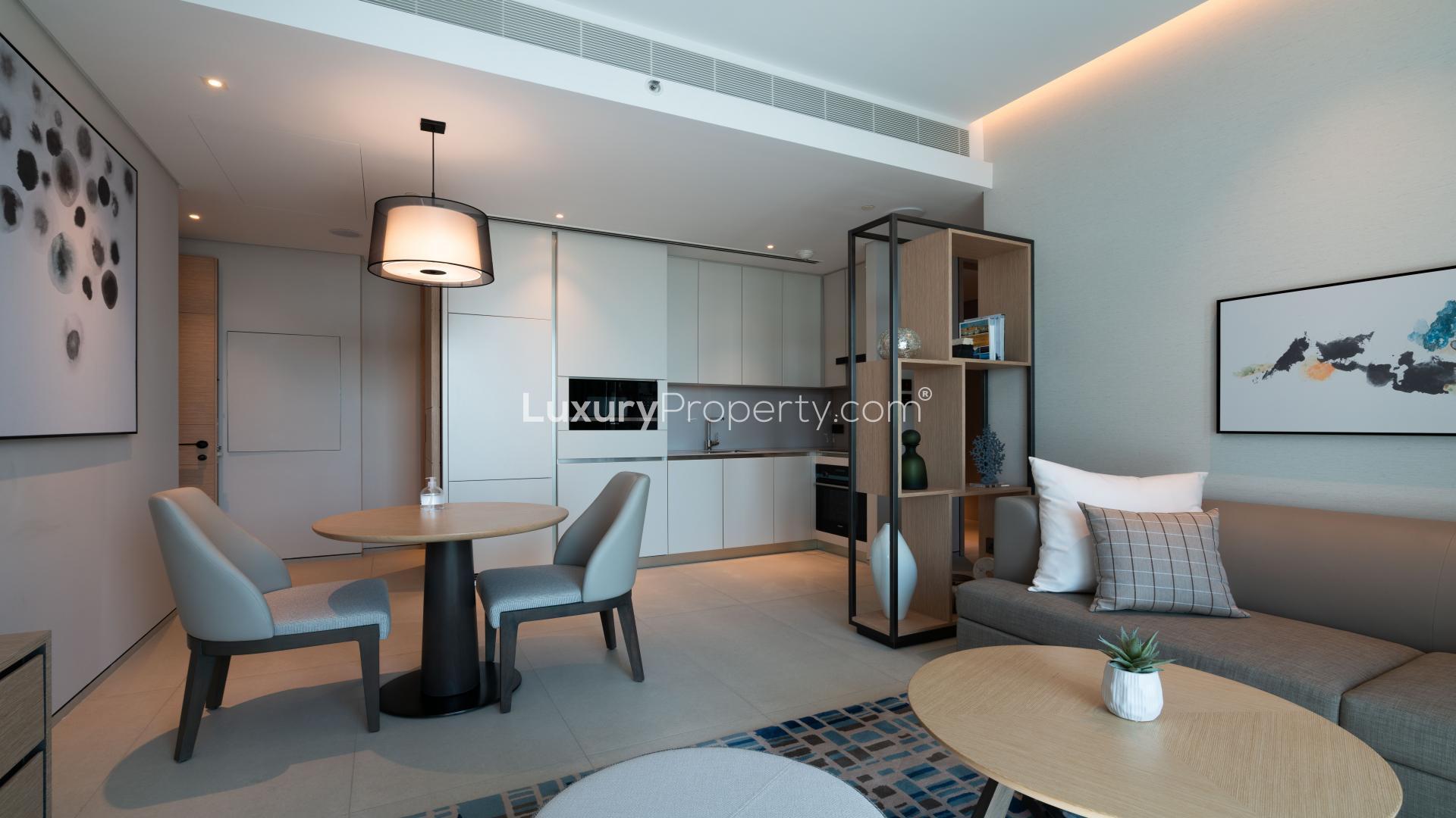 Modern living room in serviced one-bedroom apartment, Jumeirah Beach Residence, with balcony view