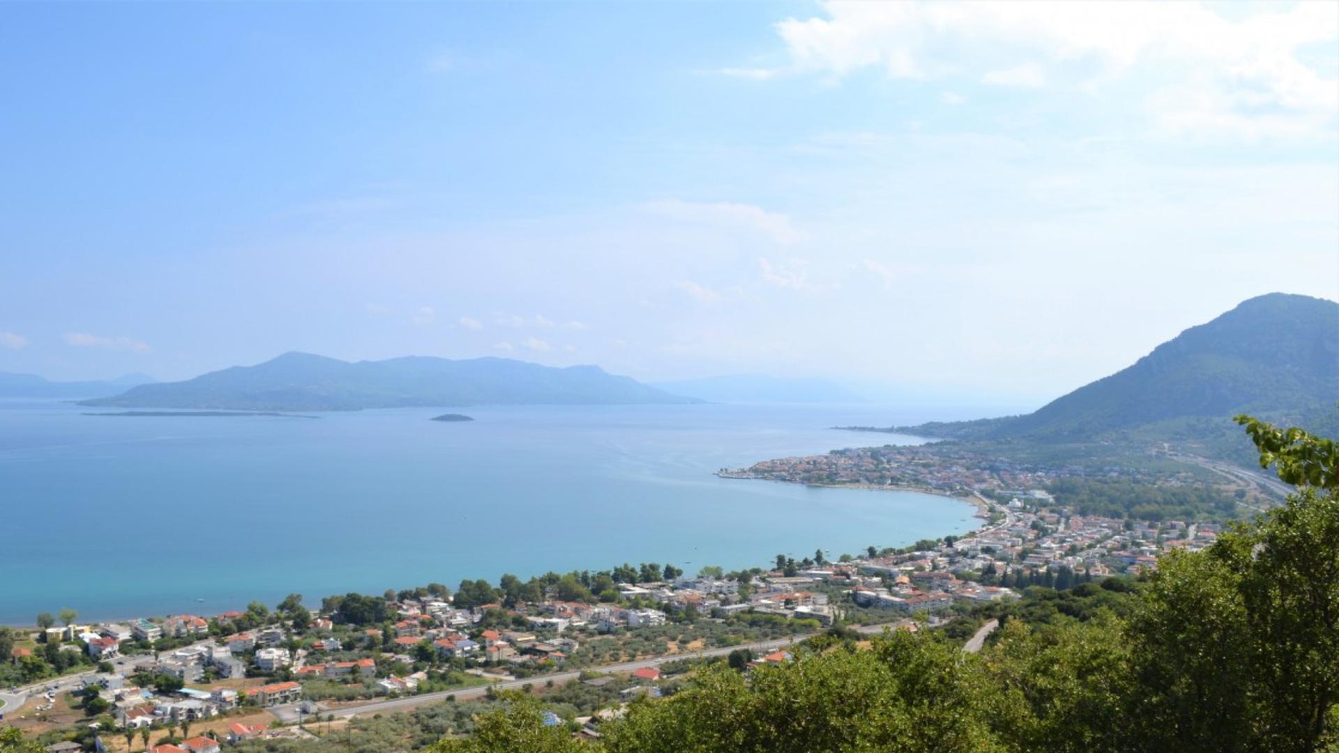 Sunset view over coastal land for sale in Kamena Vourla, Greece