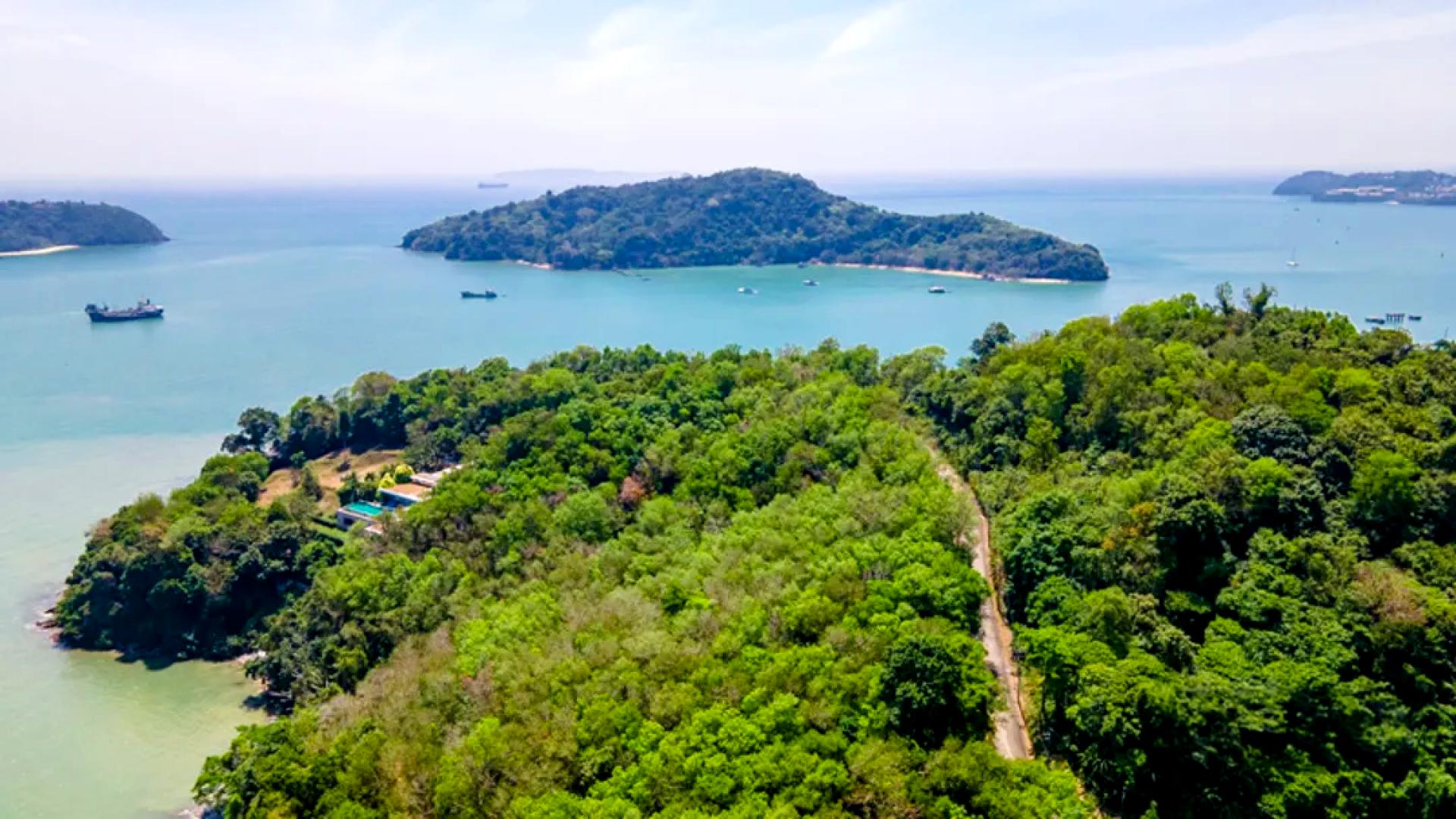 Prime sea-view land for sale in Cape Panwa, Phuket, overlooking lush greenery and ocean