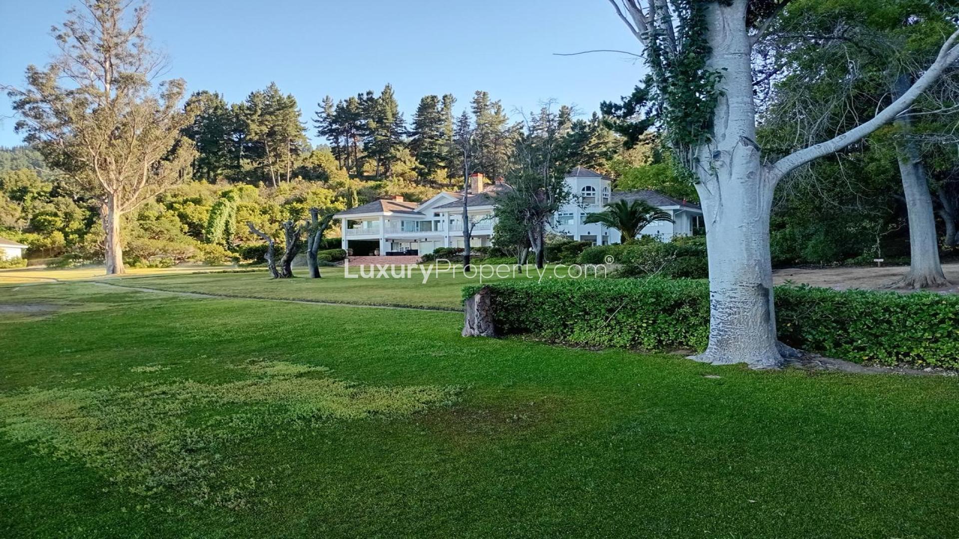 Lake Vichuquén lakefront property with lush greenery and wooden architecture, Curico Province