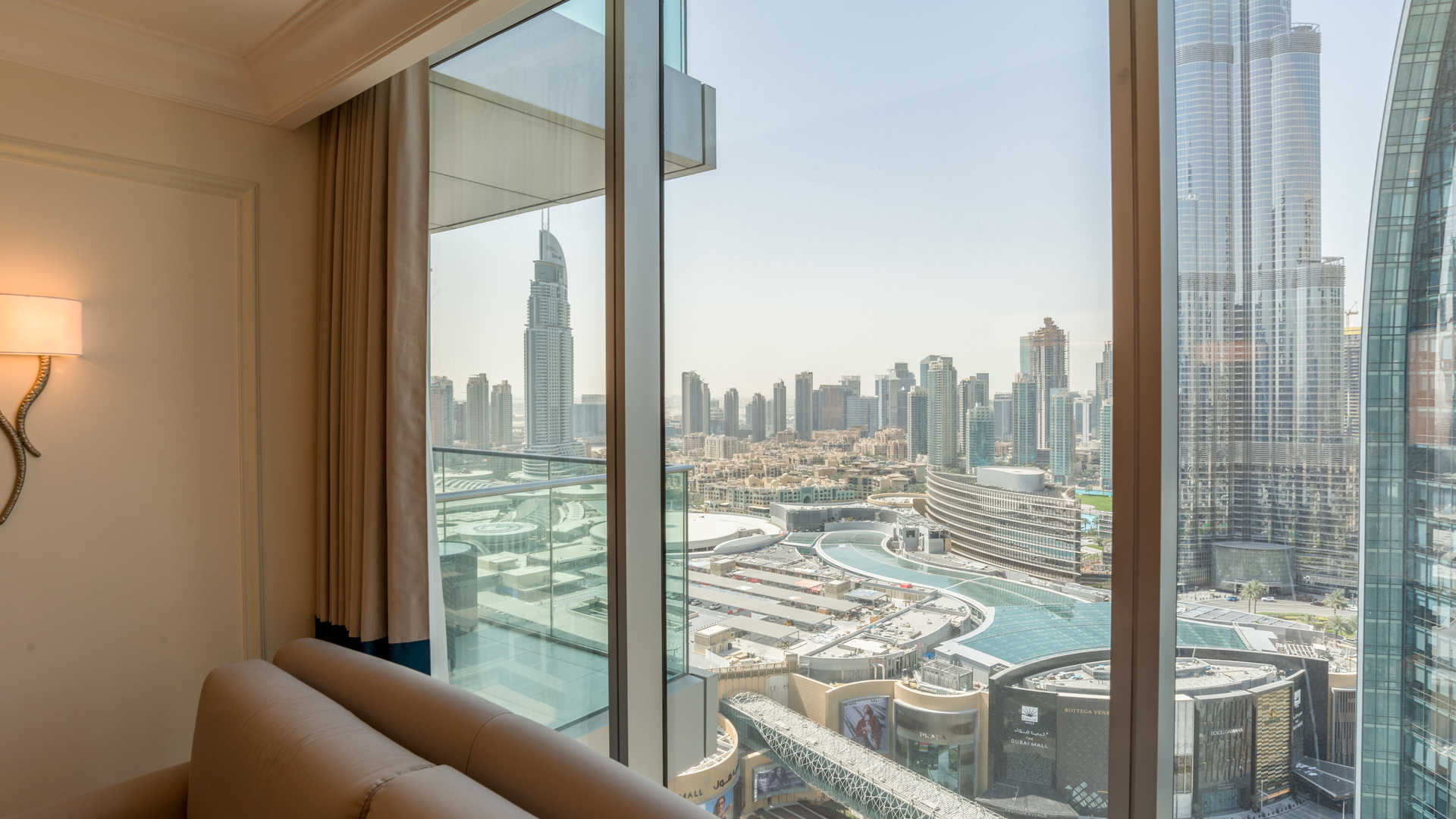"Balcony view from 1-bedroom serviced apartment at The Address, Downtown Dubai, overlooking skyline.","Spacious 1-bedroom apartment view, Downtown Dubai skyline, The Address The BLVD, for sale.",Spacious bedroom with city view in serviced apartment, The Address The BLVD, Downtown Dubai