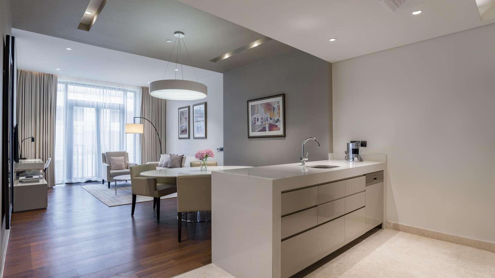 Rooftop infinity pool with stunning city skyline view at City Walk apartment