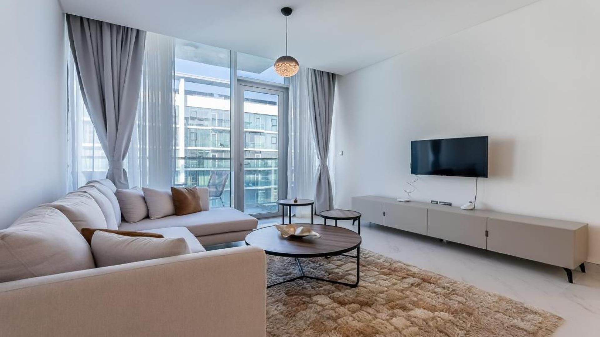 Turn-key 1-bedroom apartment living room with modern decor and lagoon view in MBR City