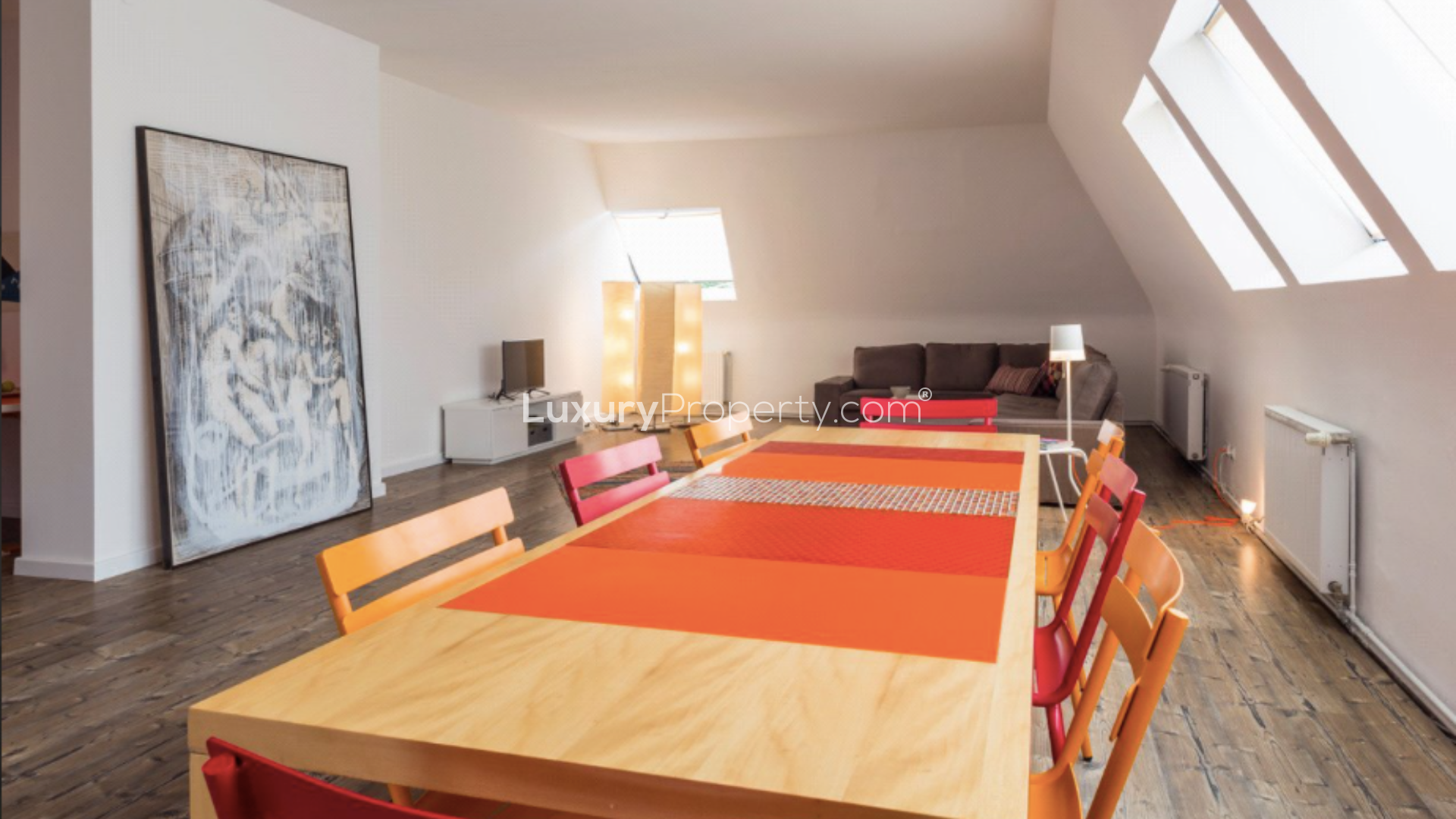 Modern living room with large sofas and fireplace in Berlin apartment for sale