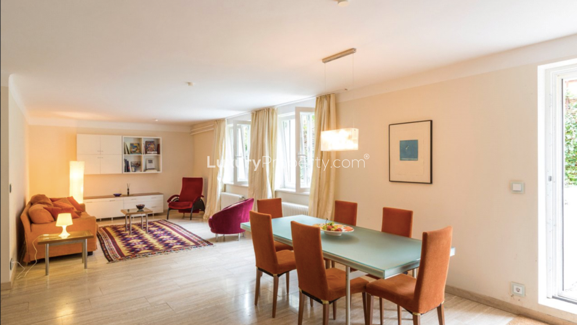 Open-plan living area in 10-bedroom Berlin apartment, featuring modern dining space and cozy seating