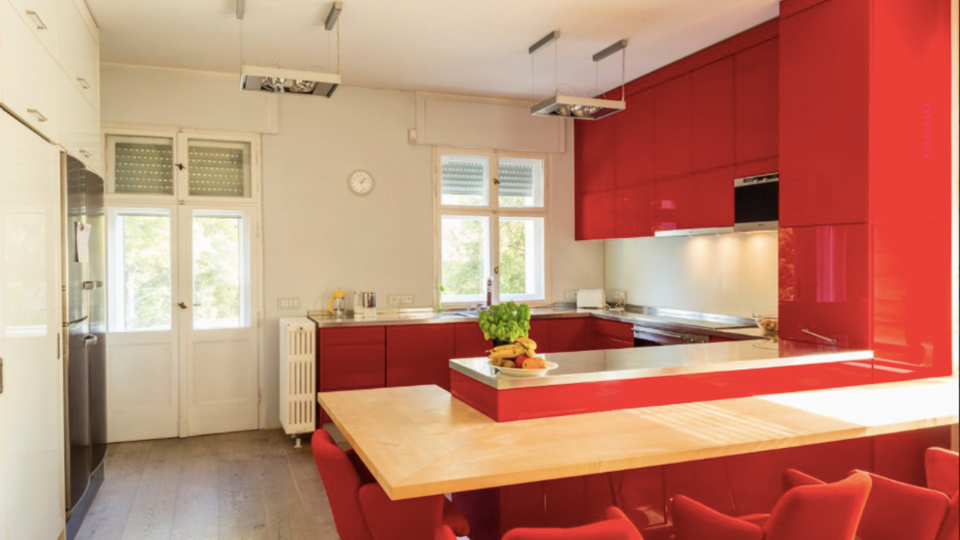 Spacious dining area in 10-bed apartment, Berlin, featuring colorful chairs and modern decor