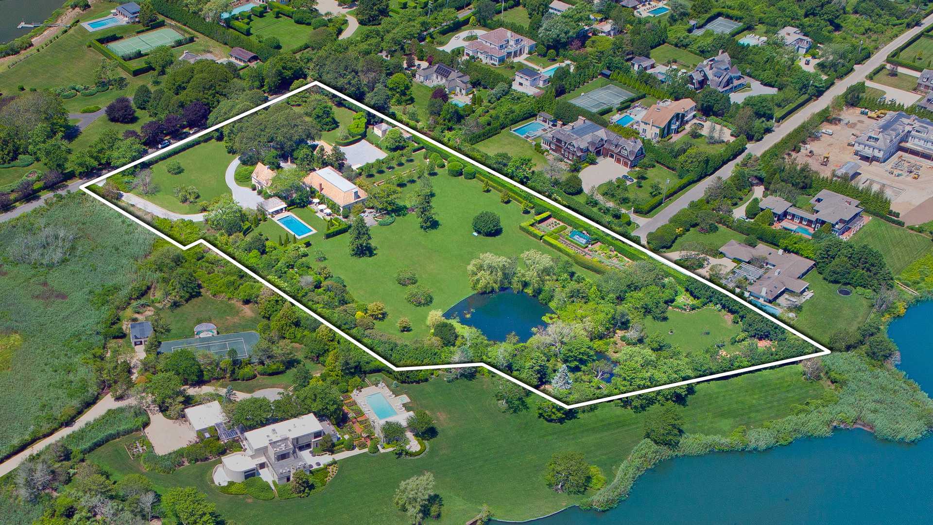 Aerial view of French-style villa with pool and gardens in Southampton, Hamptons, New York