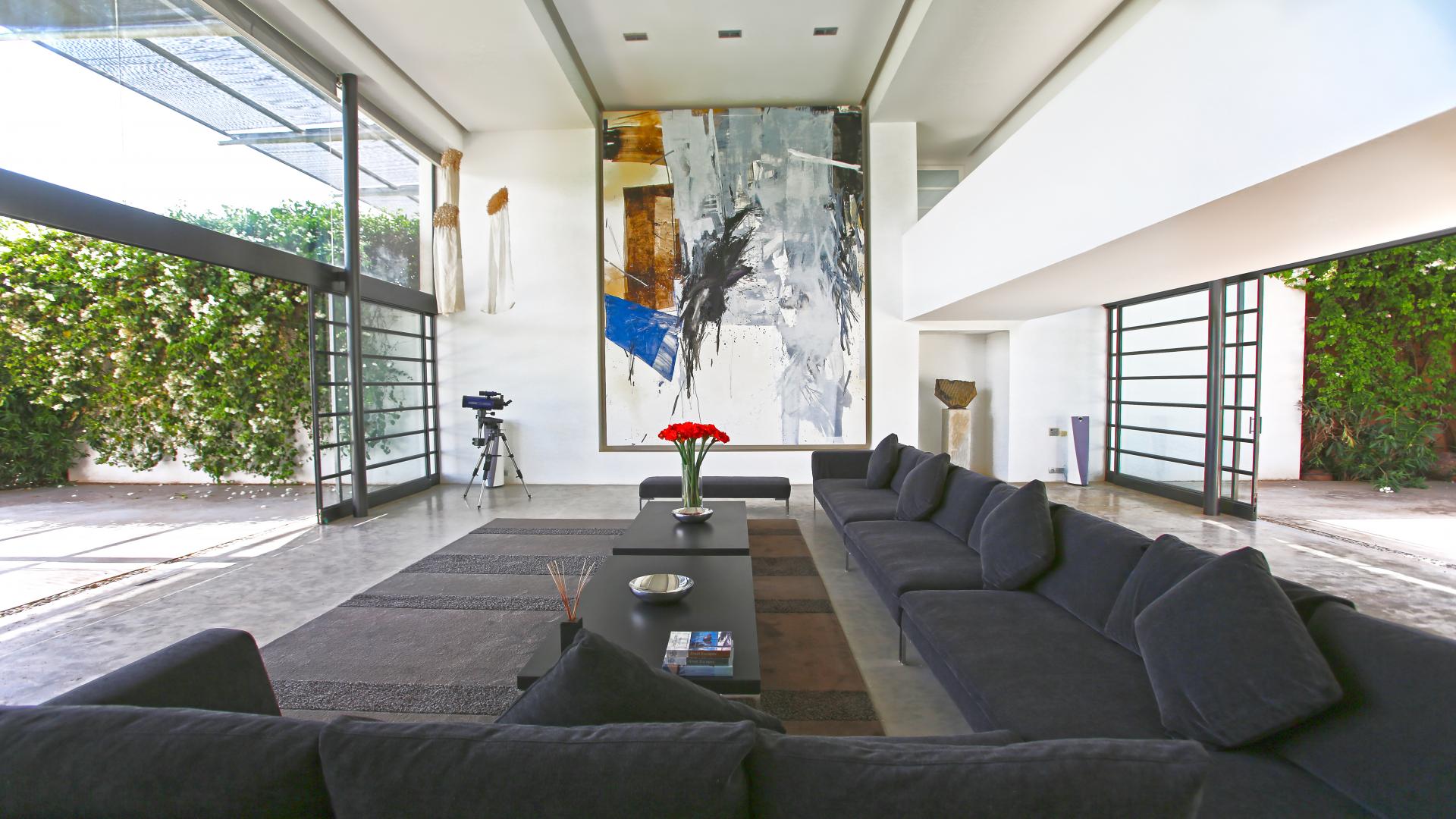 Aerial view of contemporary Marrakech villa with private lake and lush landscape